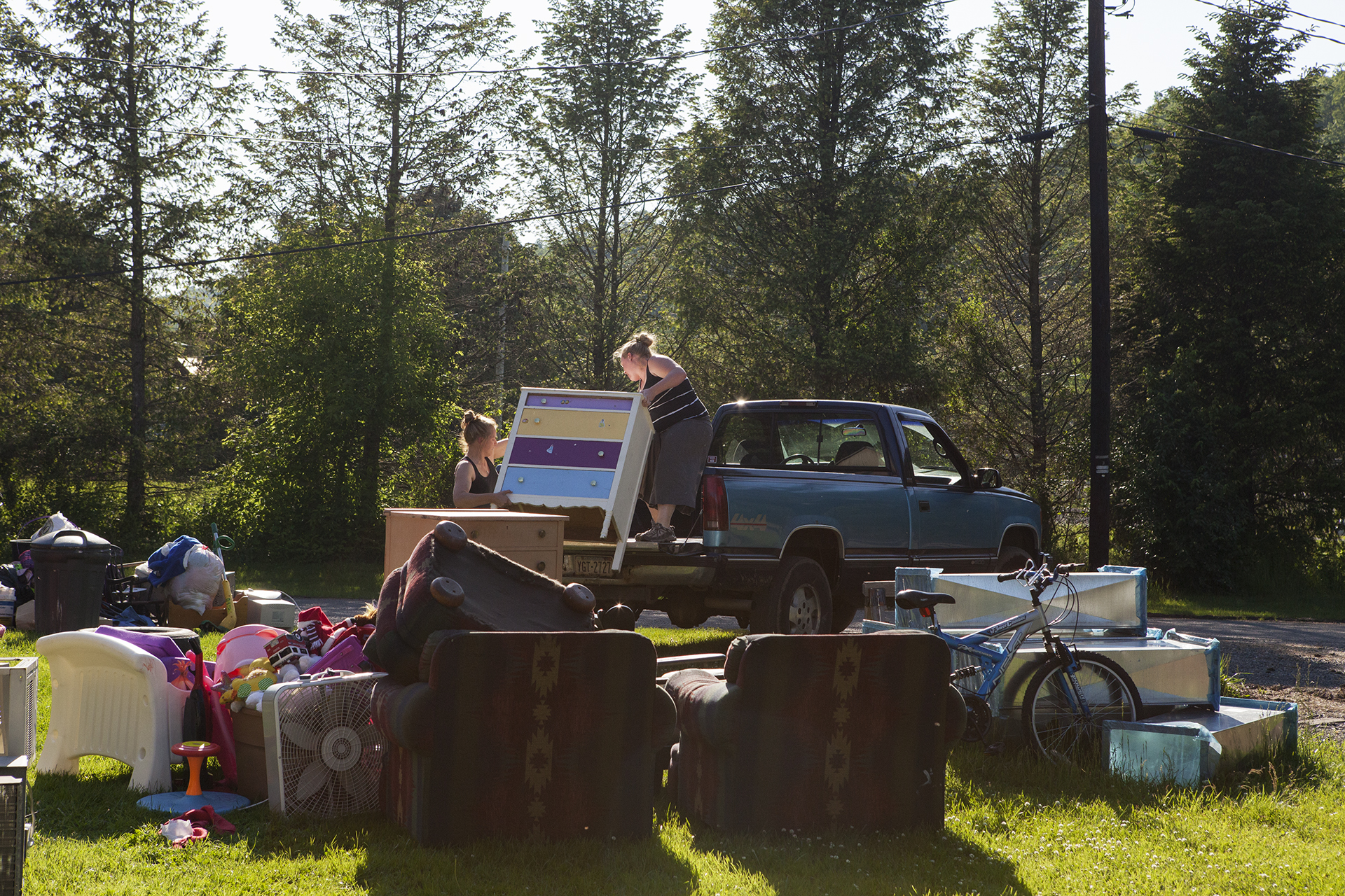 April Daniels, 24, loads her belongings onto a truck with her sister, Summer. They are relocating to Corners Trailer Park in Jersey Shore, PA.