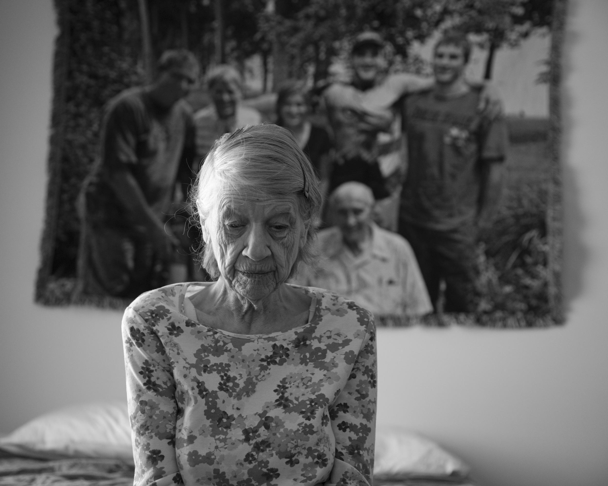  Lousie "LuLu" Walbridge, 75,&nbsp;sits in her room at Amber Way's &nbsp;Alzheimer's unit in Kalamazoo, flanked by a family portrait on Feb.&nbsp;26, 2015.&nbsp;She also suffered multiple strokes and it affected her ability to speak. 