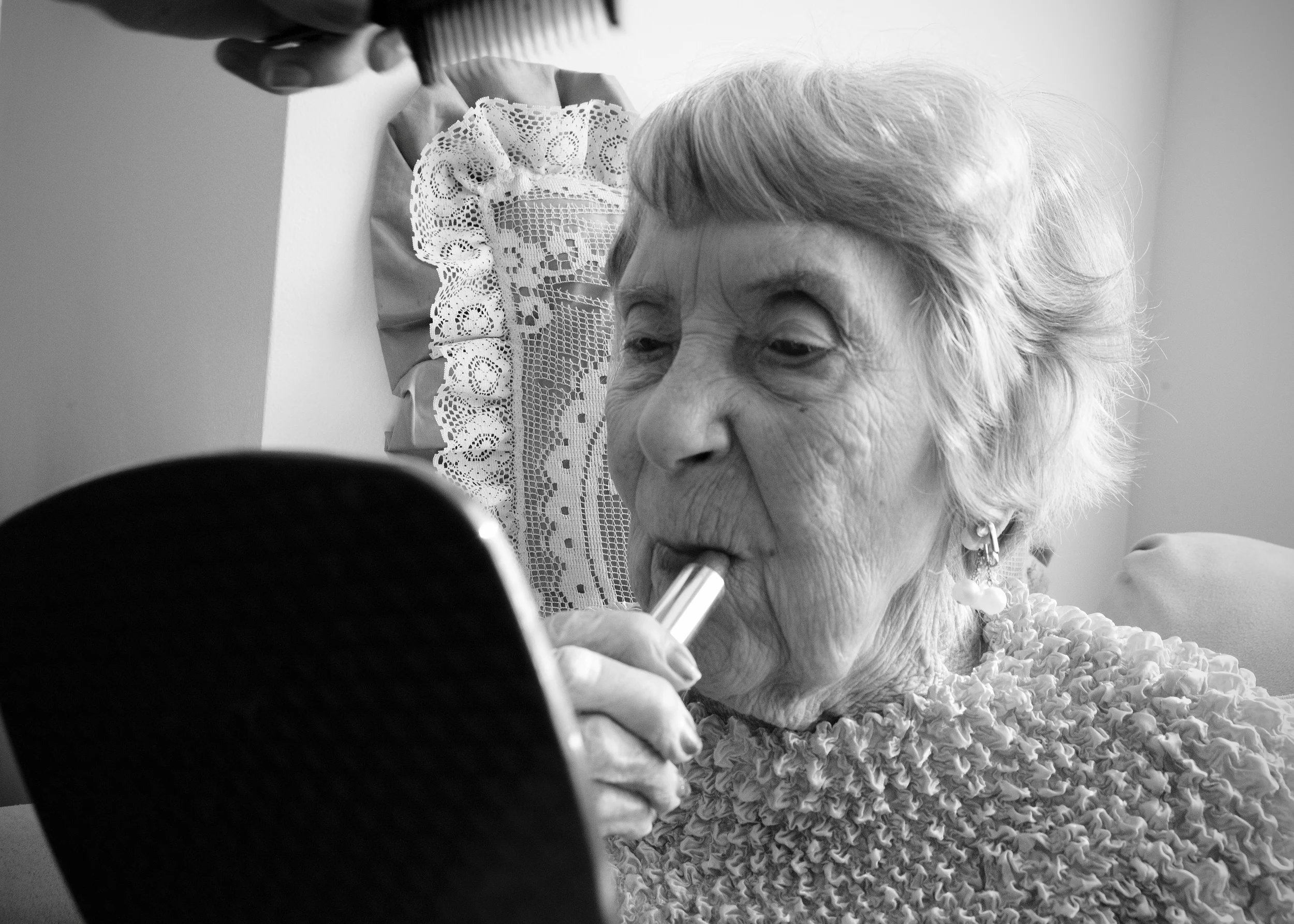 Alzheimer's resident Ruth Smith, 98, applies her lipstick before lunch at Amber Way in Kalamazoo, MI on June 3, 2015.