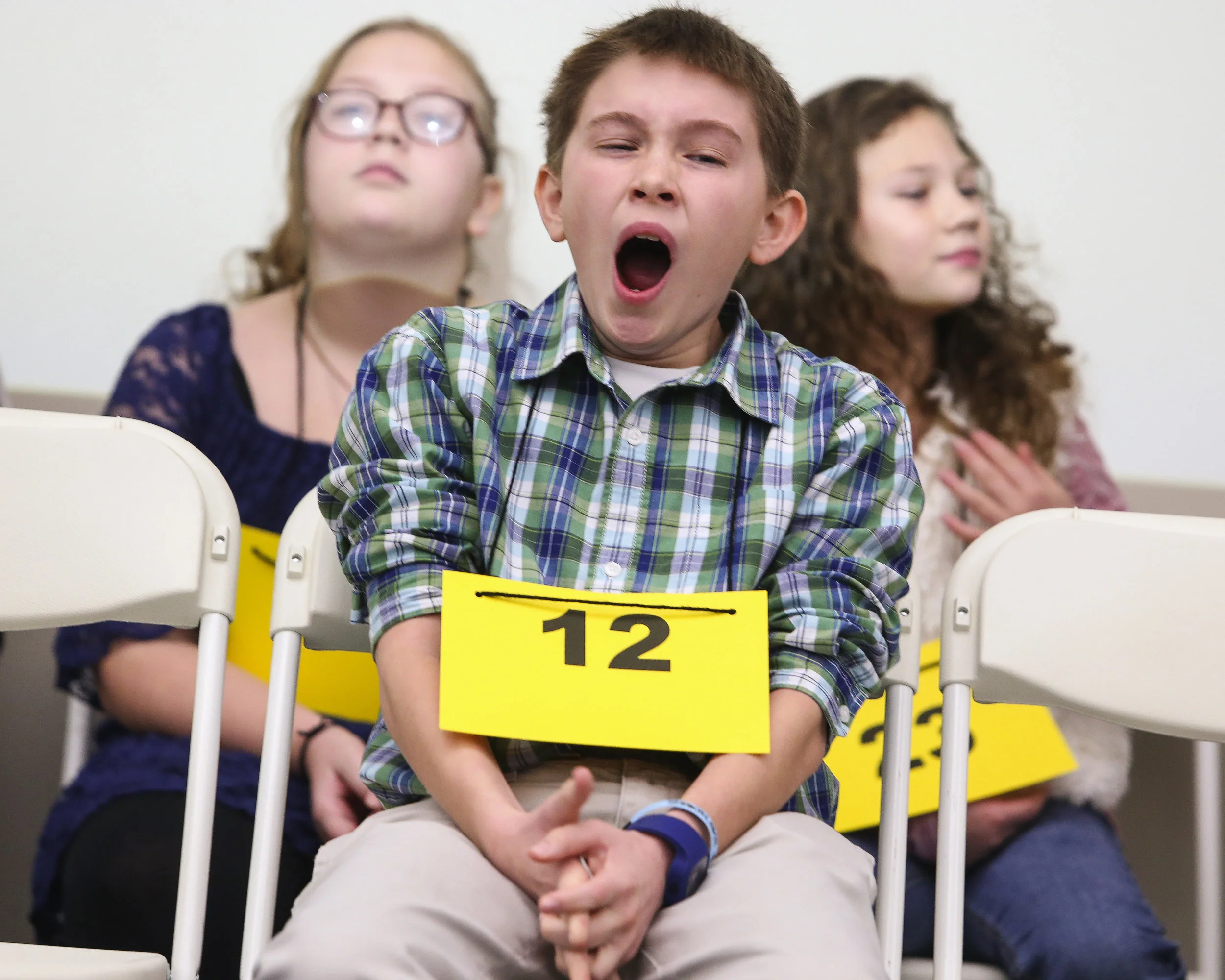  Oak Park Middle School student Colin Nelson yawns during the Morgan County Spelling Bee at Calhoun Community College Aerospace Training Center in Decatur, Alabama. 