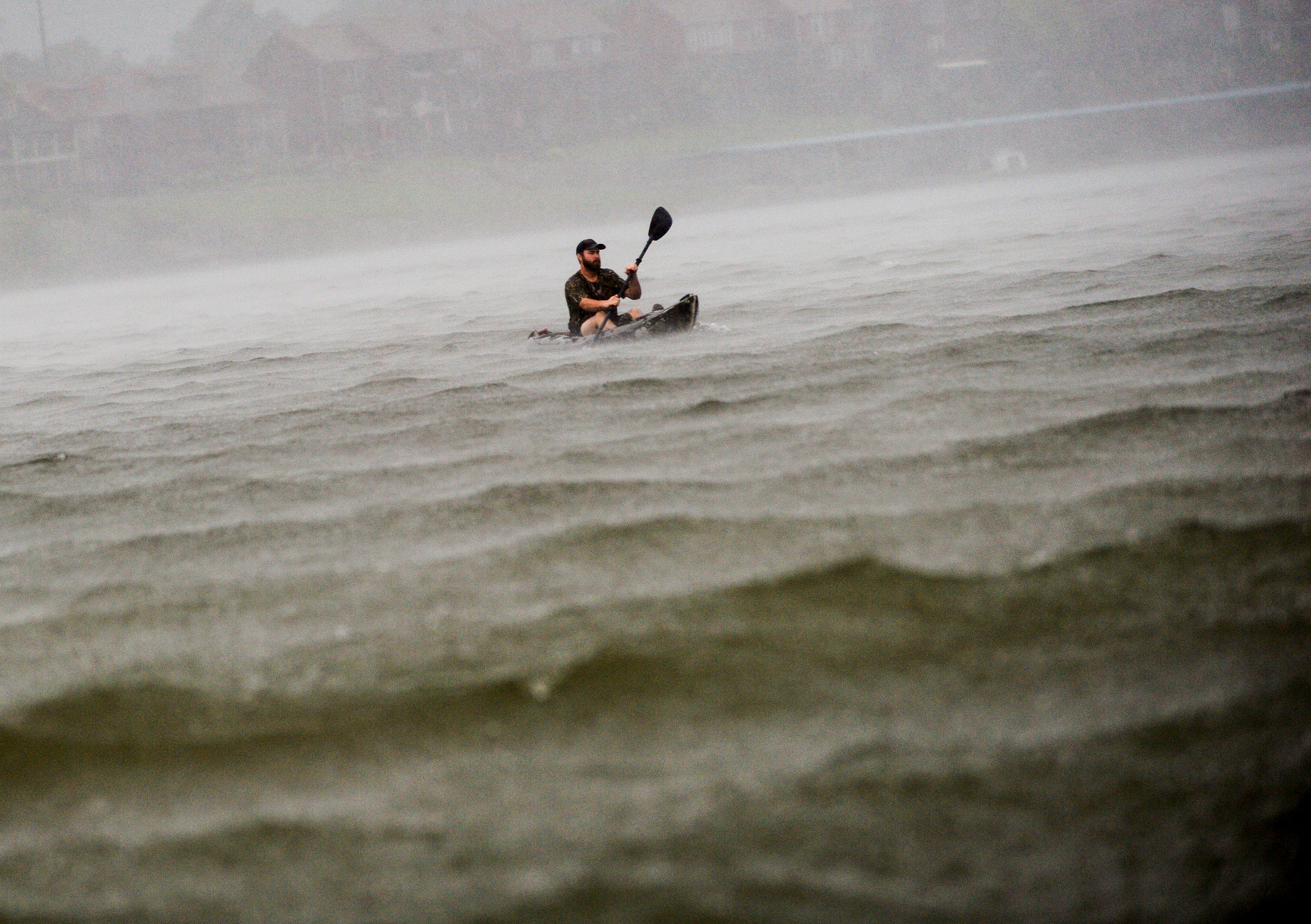 A man kayaks during a tornado warning on the Tennessee River in Decatur, Alabama.
