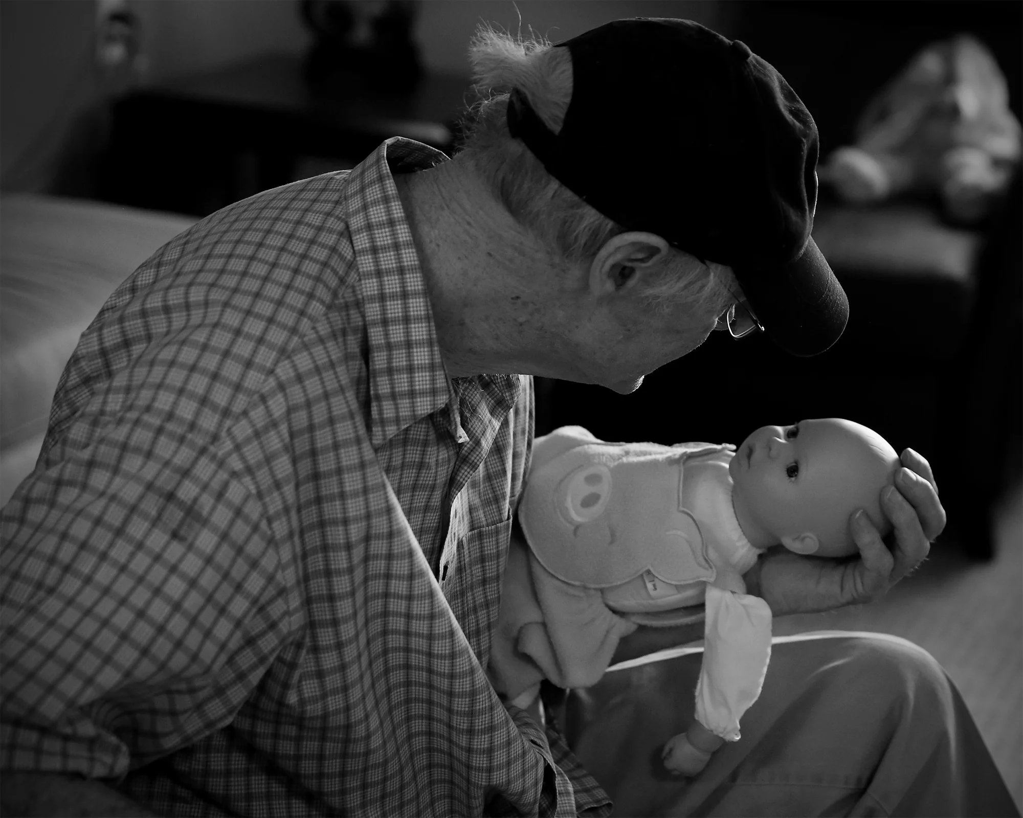 Les Mitchell takes care of a baby to calm himself and focus at the Alzheimer's unit at Amber Way in Kalamazoo, Michigan.