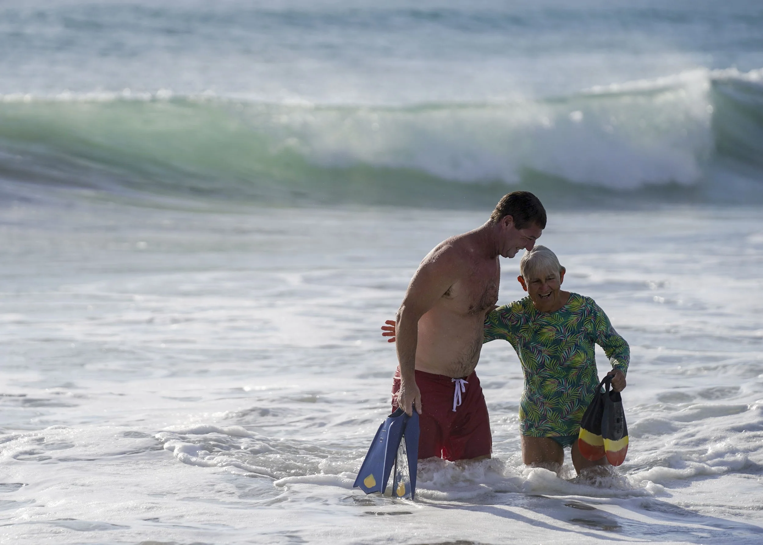  Campbell (right), 81, and Mike Mammen, a lifeguard with Martin County Ocean Rescue, head to the beach after body surfing together during a Surfers for Autism event, Saturday, Sept. 10, 2022, at Jensen Beach Park. After her husband Arthur passed away