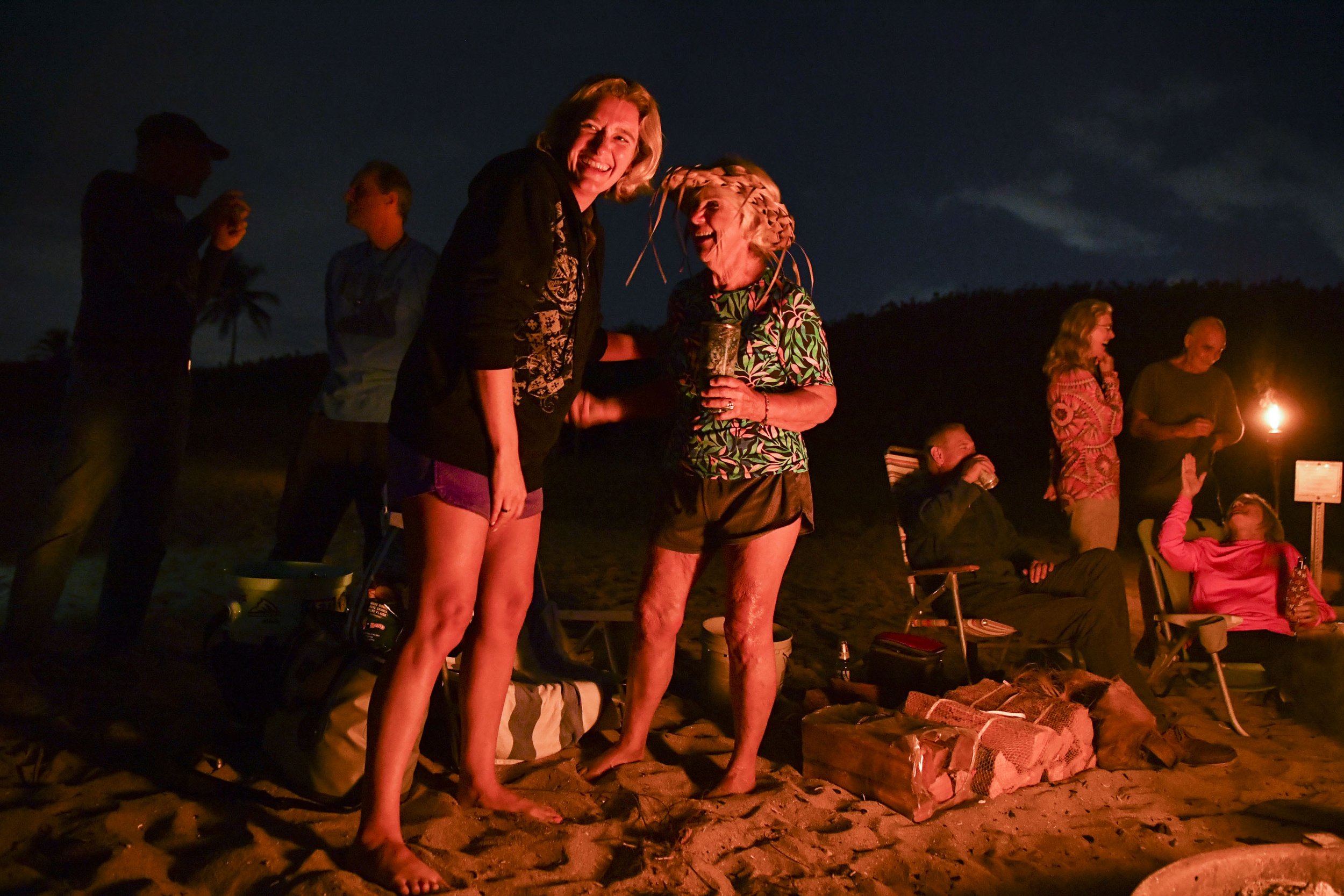  Ellie Golden (left), laughs with Campbell during a full moon bonfire, Thursday, Dec. 5, 2023, at Stuart Beach. Campbell organized the event for all her surfing and beach friends. "Nicki is just an amazing woman," said Golden. "She's a role model and