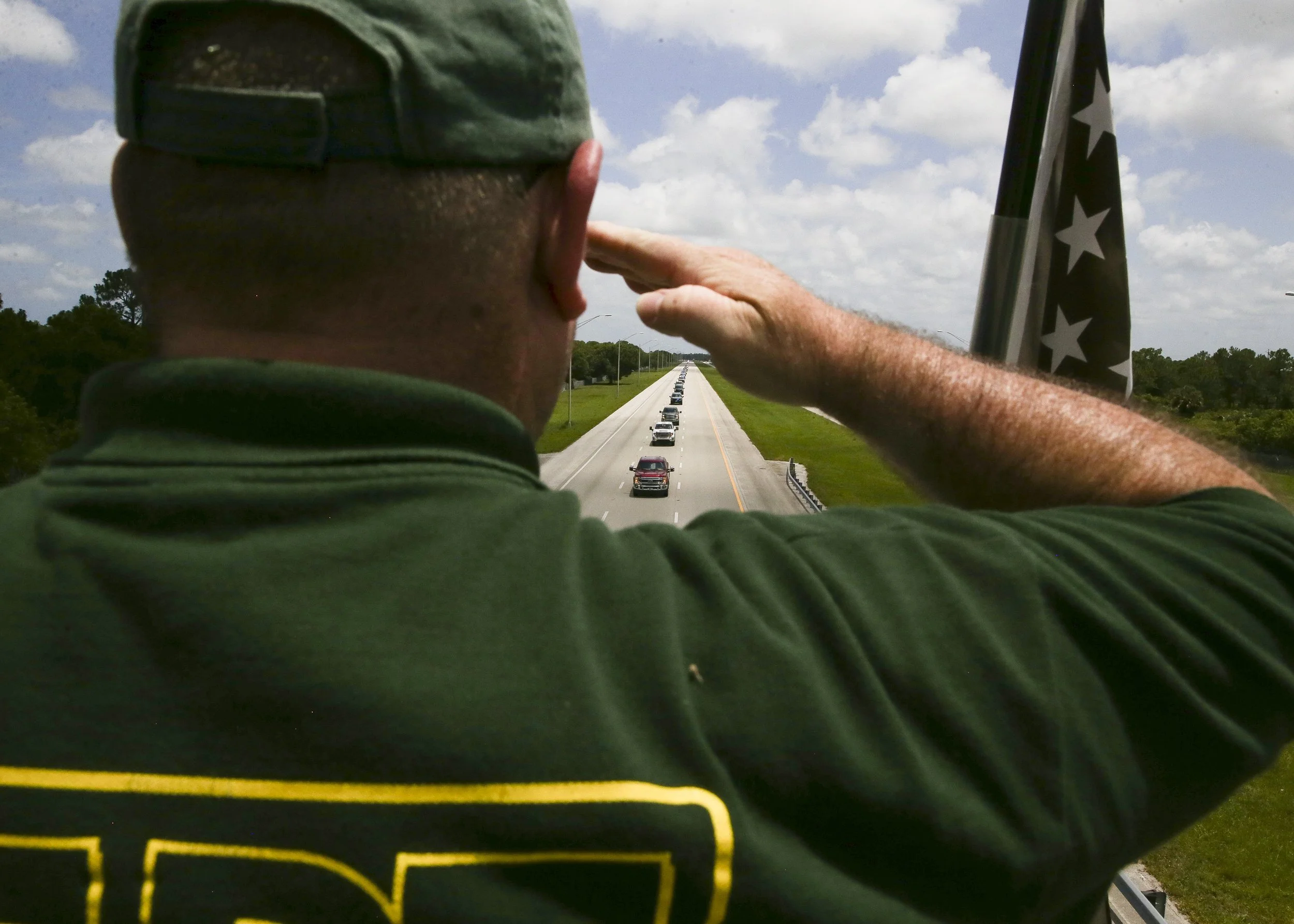  "I'm happy to be here for his family and honor his service," said Danny Vinson, of Vero Beach, who pays his respects as the funeral procession of Kyle Patterson passes the Oslo Road I-95 overpass Friday, June 17, 2022, in Indian River County. Patter