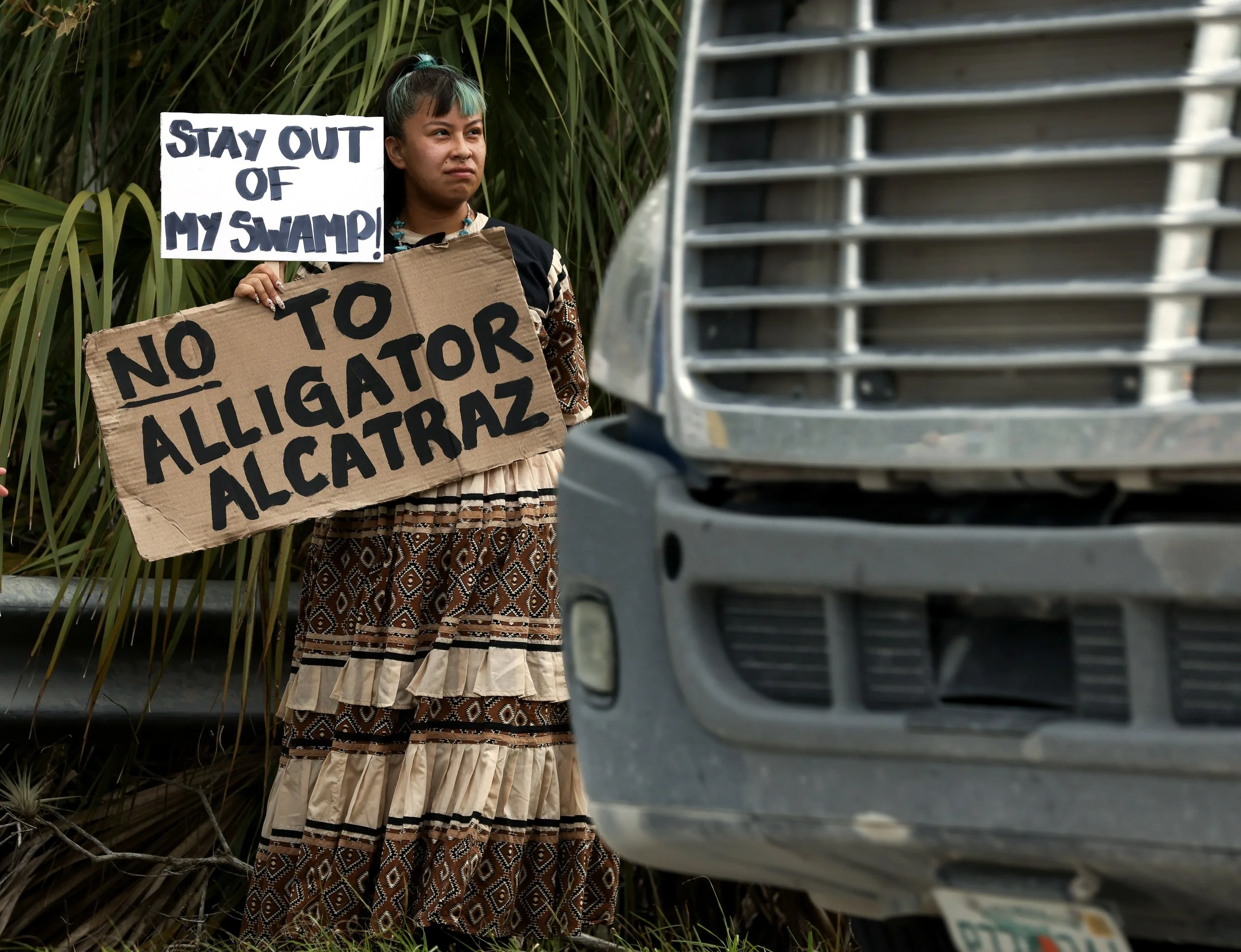  People gather in front of the access road into the Dade-Collier Training and Transition Airport to protest the construction of Alligator Alcatraz, an immigrant detention center, in the Big Cypress Wildlife Management Area on Saturday, June 28, 2025.