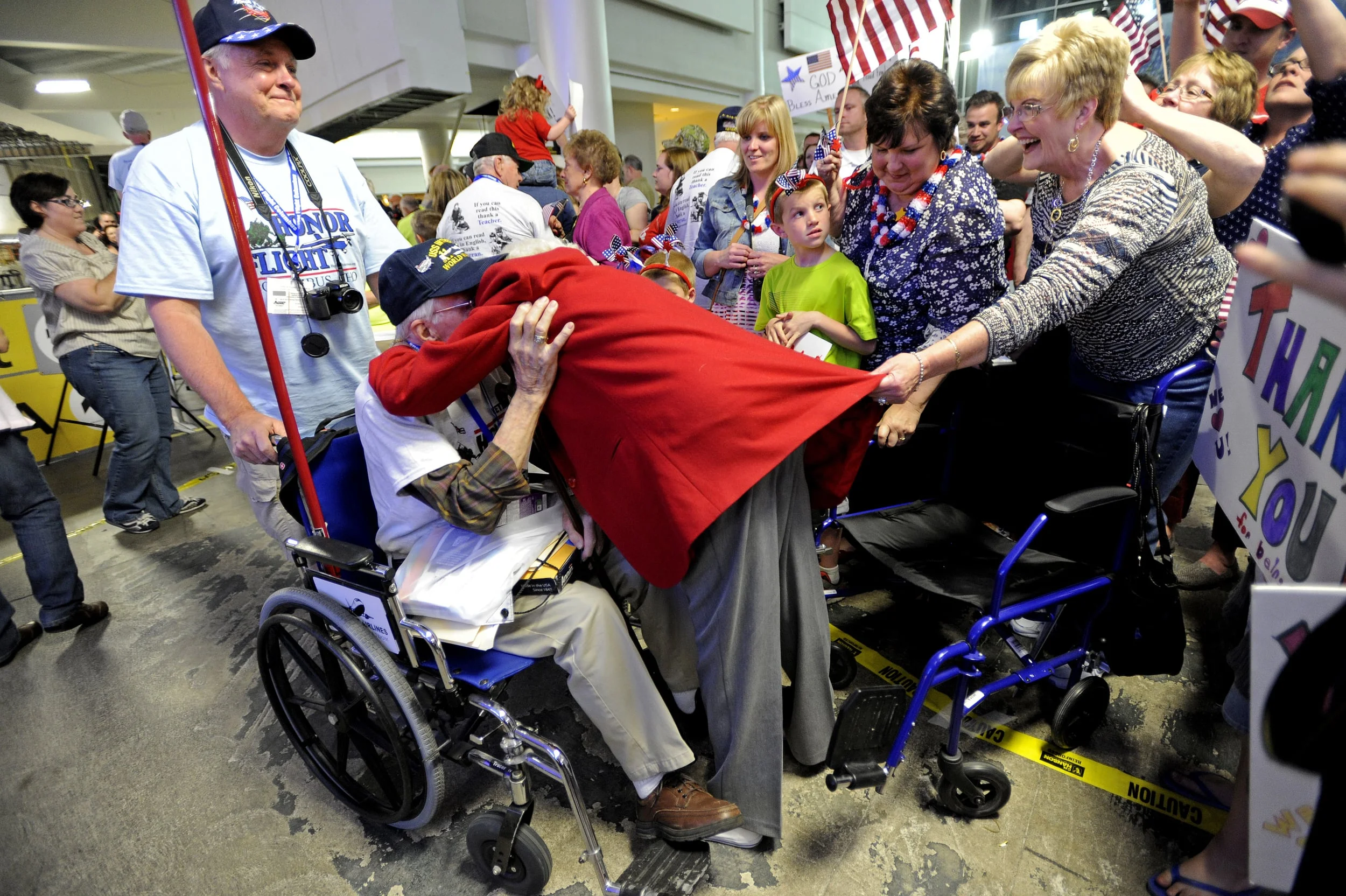 An eager wife pulled herself out of her wheelchair and into her husbands arms in a heartwarming embrace after the Honor Flight returned to Columbus. The veterans disembarked from the plane at Columbus International Airport close to 9:30 p.m. after getting to the airport before 5:30 a.m. in the morning to begin their adventure to the biggest surprise of the day- between 400 and 600 of their closest family and friends waiting to give them a hero's welcome home.