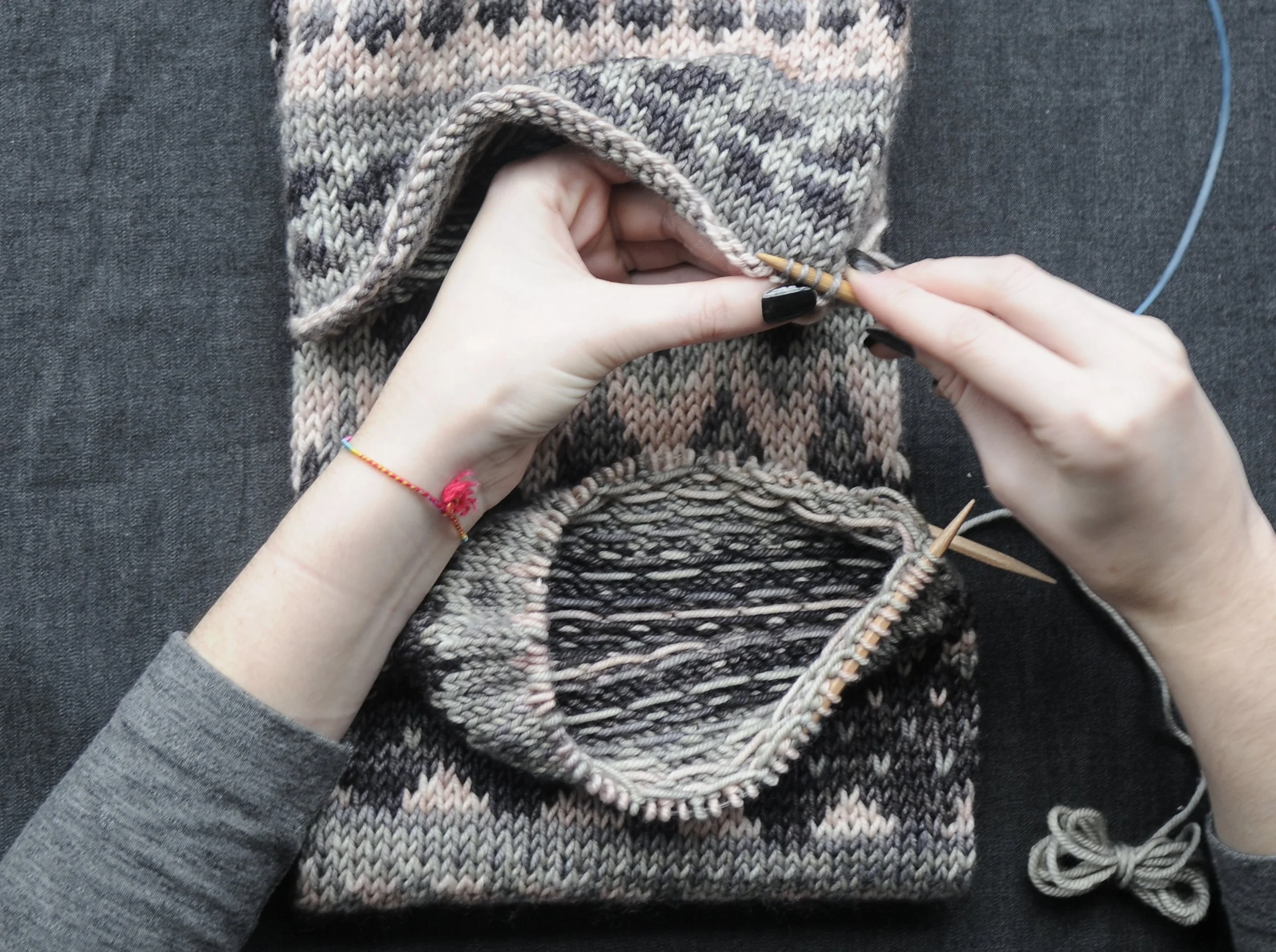 2: With your second circular needle, pick up the stitches just above your Provisional Cast On by sliding the needle into the right side of the stitch, moving right to left. Once all stitches are picked up, remove waste yarn.