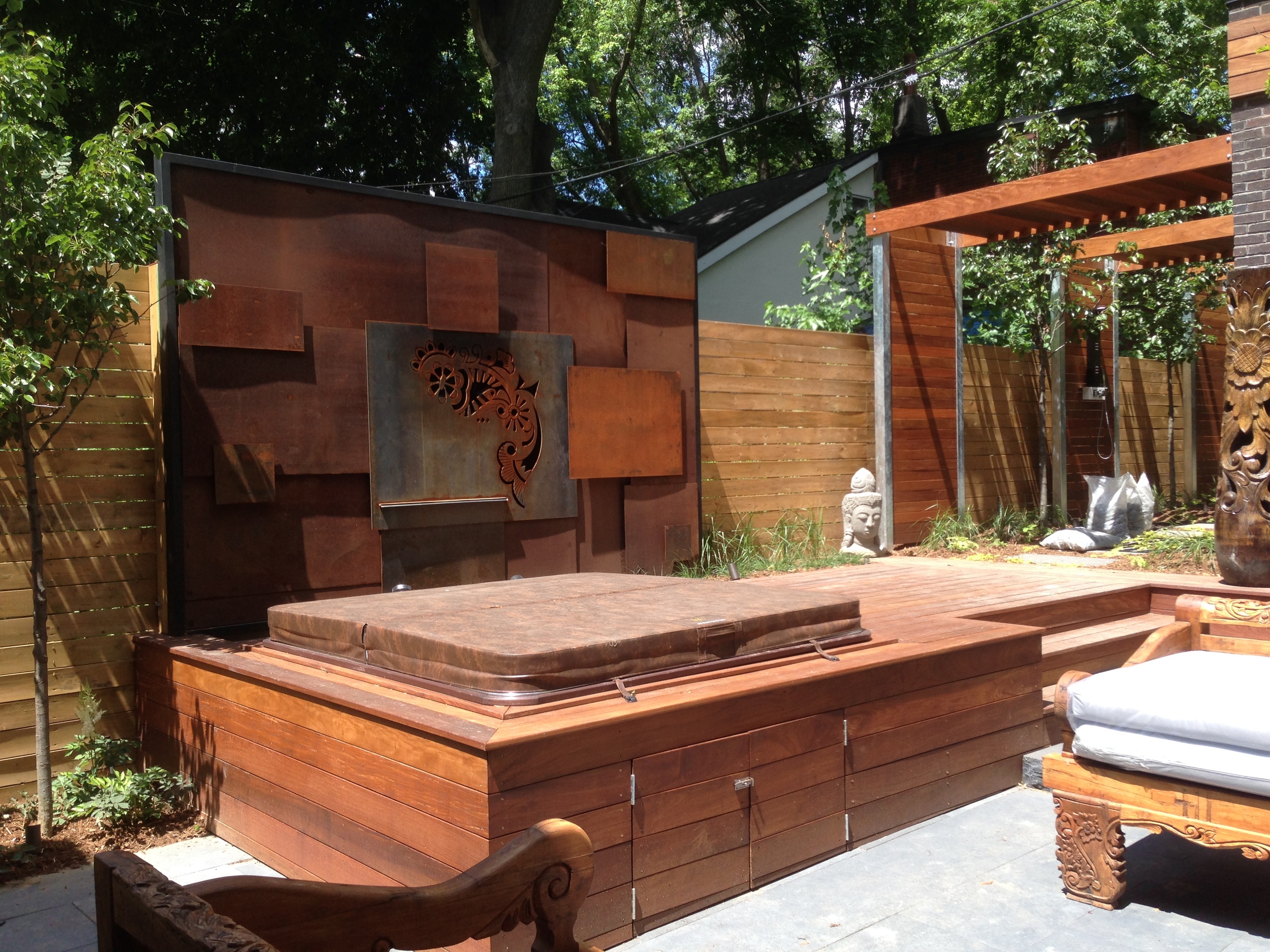 The custom corten steel water feature almost complete to create a seamless look of cascading water into the built-in spa.
