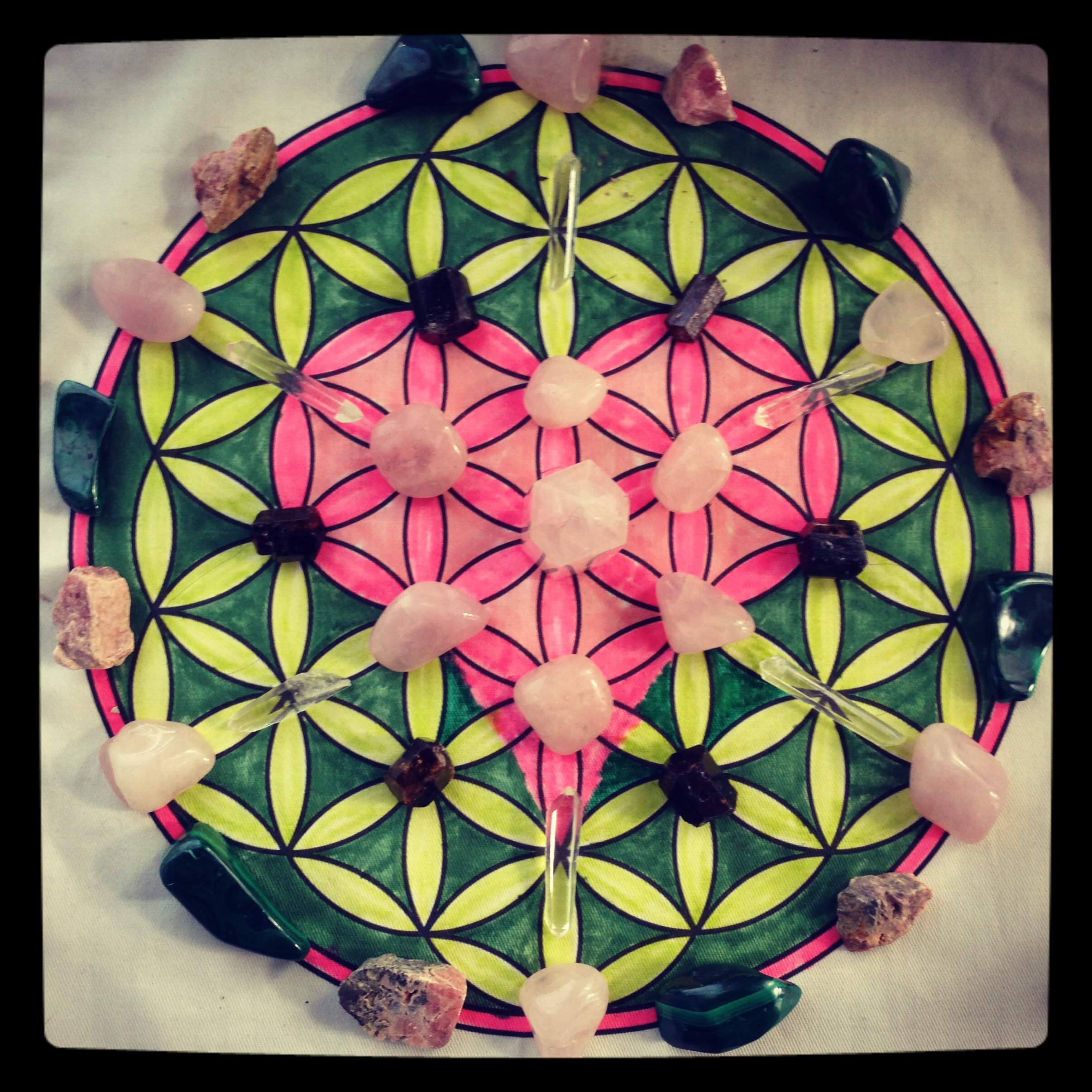 This grid is centered with Rose Quartz tower with Rose Quartz coming out from the center, then Dravite (or champagne Tourmaline, a wonderful stone for self-compassion), on the outer ring, Rose Quartz, Malachite, and Rhodochrosite.