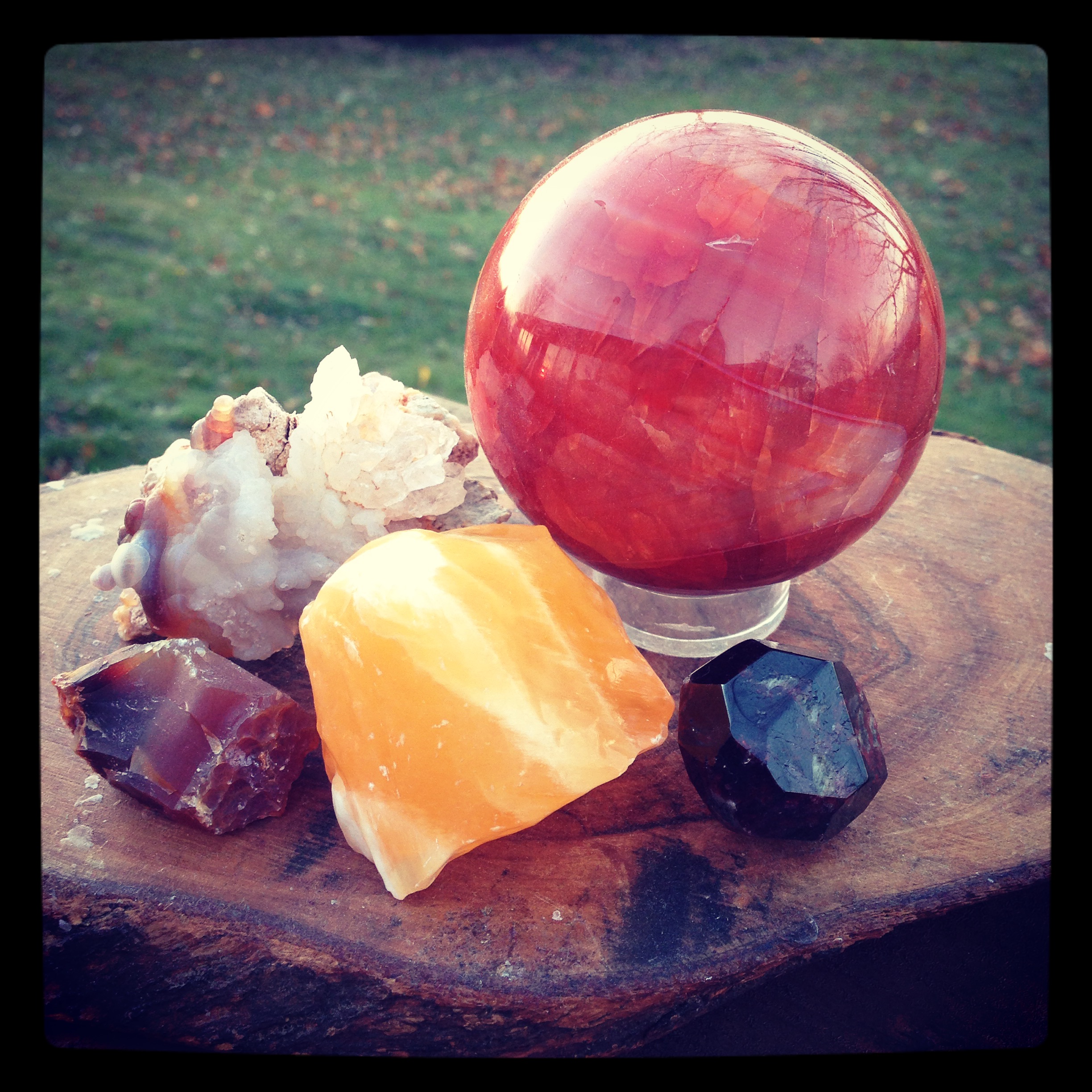 From 12 O'clock, Carnelian sphere, Garnet, Orange Calcite, raw Carnelian, and Fire Agate.