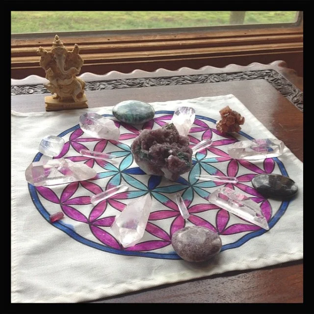 Forgiveness grid centered with lepidolite. Around the edges are lepidolite, rubellite, optical quartz, green kyanite, aragonite, astrophyllite and clear quartz points.