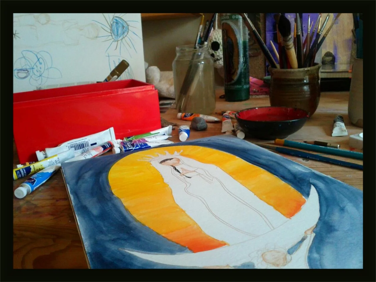 Working on a painting of the Virgin of Guadalupe
