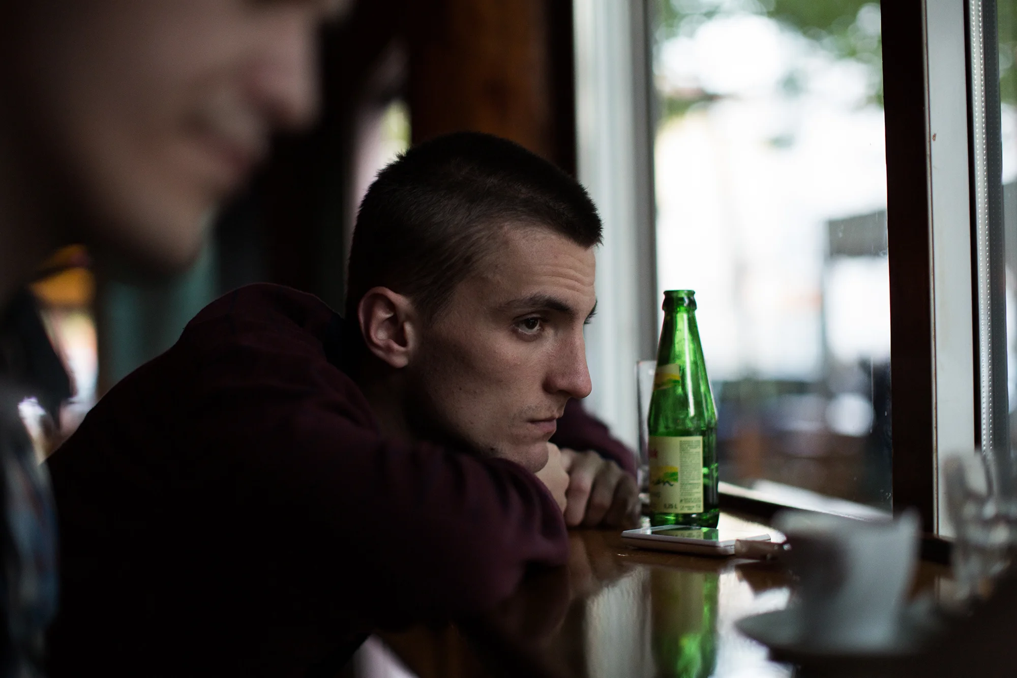 Marko Subasic (left), a Bosnian Croat, gets a drink with his roommate, Ilija Knezevic (center) at the bar Hemingway. Marko, after searching for a job in Bosnia after finishing his bachelor's degree, went back to school because he couldn't find employment. So now that he's about to finish his master's degree, he has decided to move abroad on a scholarship to work.