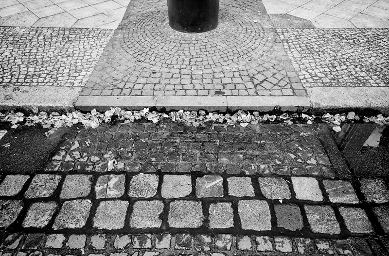 PETER FECHTER A cobblestone path marks the former location of the wall along Zimmerstrasse, where on August 17, 1962, a teenager from East Germany, Peter Fechter, was shot in the back as he attempted to escape over the Wall with his friend Helmut Kulbeik. He laid tangled in barbed-wire and bled to death an hour later in plain view of Western and East German onlookers. Despite his screams for help, he received no medical attention. In March 1997, two former East German guards, Rolf Friedrich and Erich Schreiber, faced manslaughter charges for Fechter's death. They admitted to his shooting and both were convicted and sentenced.