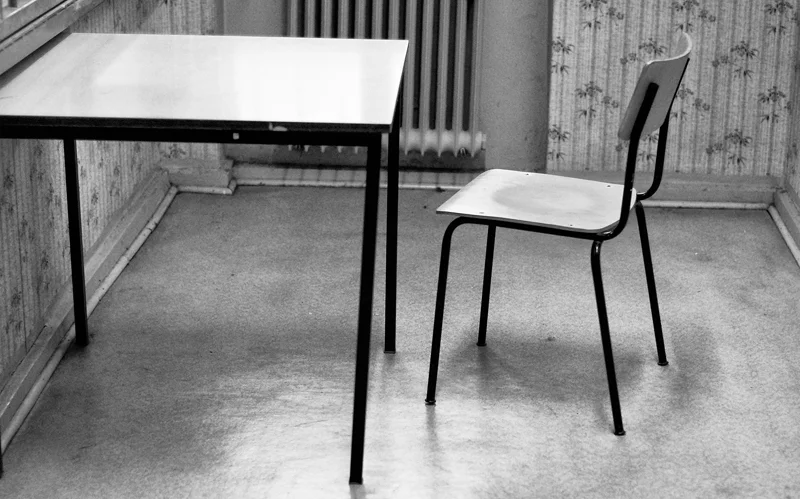 INTERROGATION A lone chair sits in an interrogation room in the Stasi prison. More than 200 cells and interrogation rooms existed in the interrogation wing of the prison. Prisoners were isolated from the outside world, and expert interrogators subjected them to months of questioning. The interrogators would coerce victims into making incriminating statements.