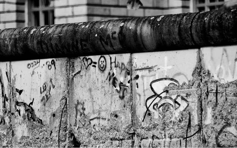 DIE MAUER Ultimately, the Wall was built to stem the flow of refugees to the West and protect the economy of East Germany. This was the fourth wall in Berlin’s history. The first two were built to protect the city from invasion. The third helped enforce levies and taxes.