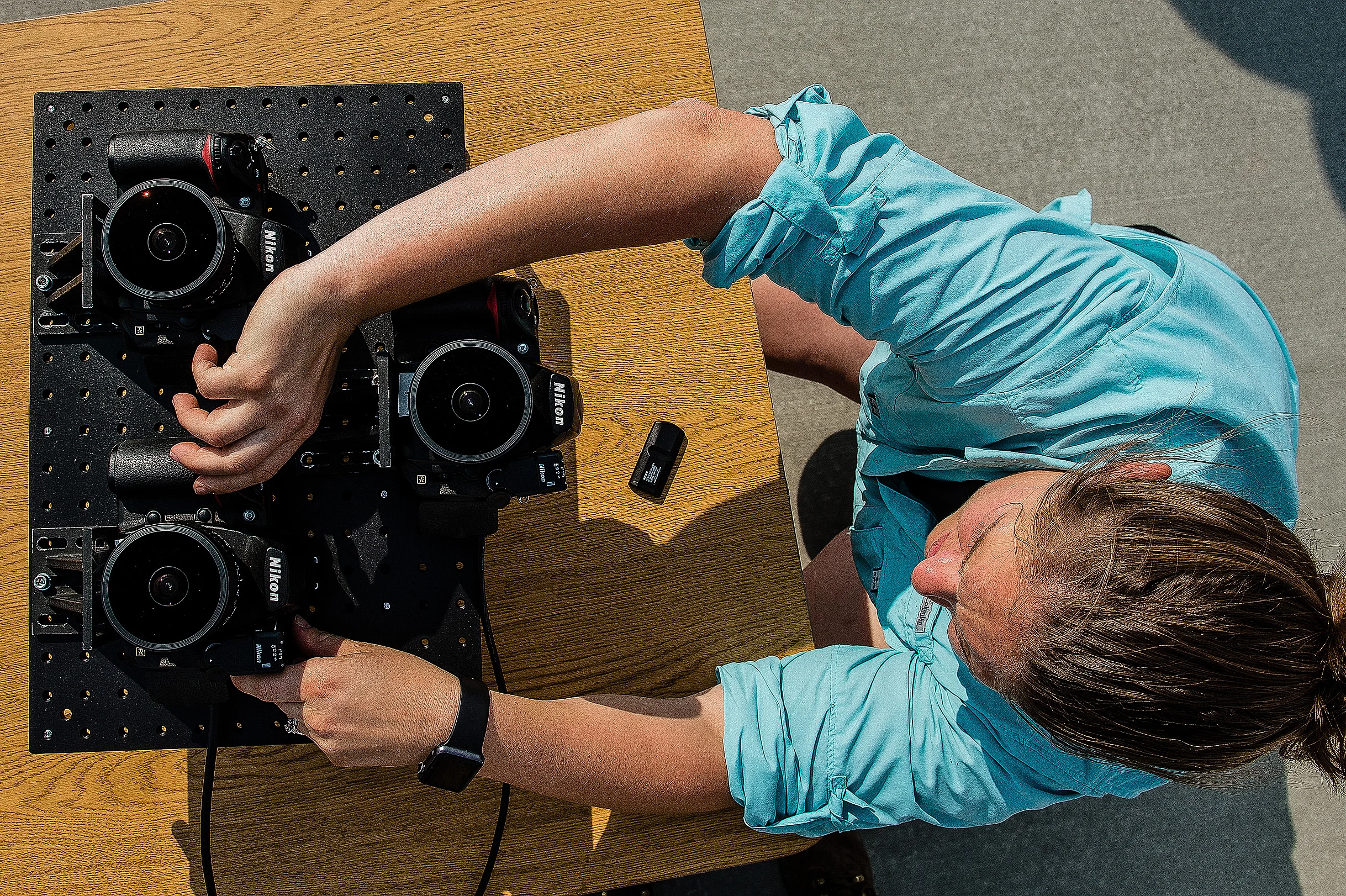 A Montana State University engineering student prepares a camera array that would analyze polarization of the sky during the total solar eclipse.