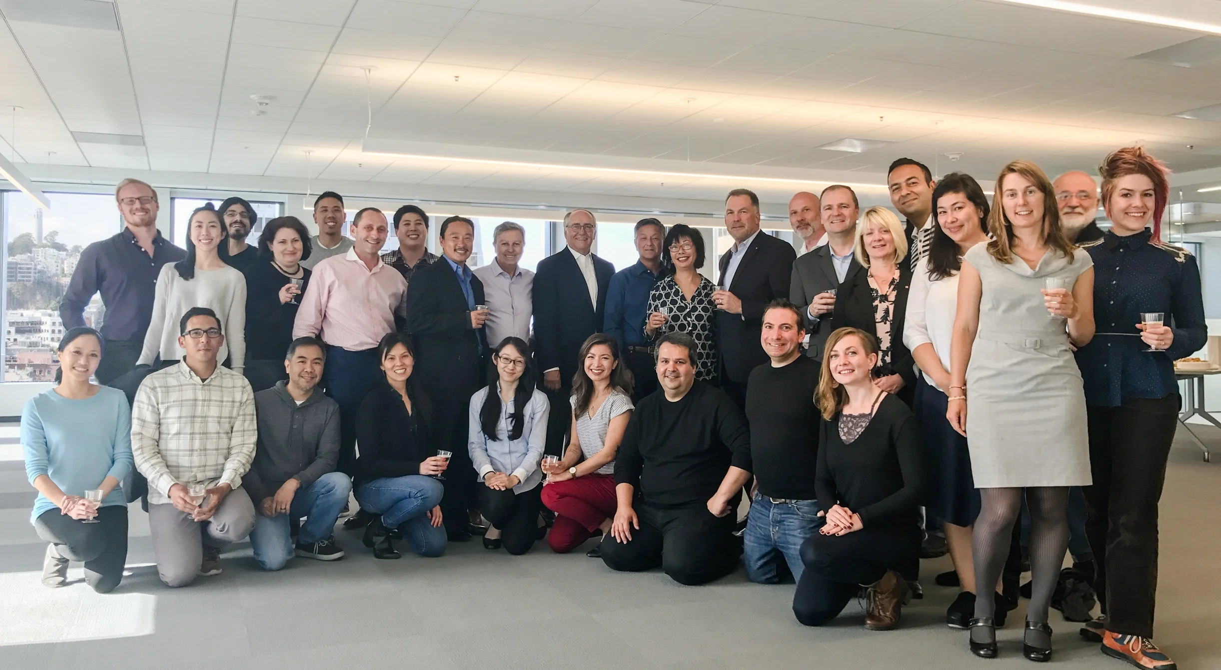 Kwan Henmi celebrates the merge with DLR Group in one of KH's newly designed suites in 456 Montgomery Street. Pictured here: Kwan Henmi team with Griff Davenport, Pamela Touschner, Adrian Cohen, John Fuller, and Dale Hallock of DLR.