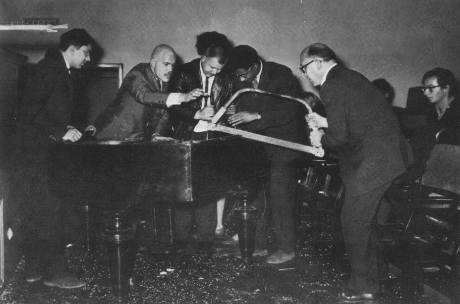 George Maciunas, Dick Higgins, Wolf Vostell, Benjamin Patterson & Emmett Williams performing “Philip Corner’s Piano Activities” at “Fluxus Internationale Festspiele Neuester Musik,” Weisbaden (1962). Photograph by Hartmut Rekort.