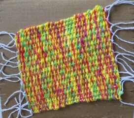 Sunshine weave (double strand yarn on homemade loom) by Poppy Yule age 9