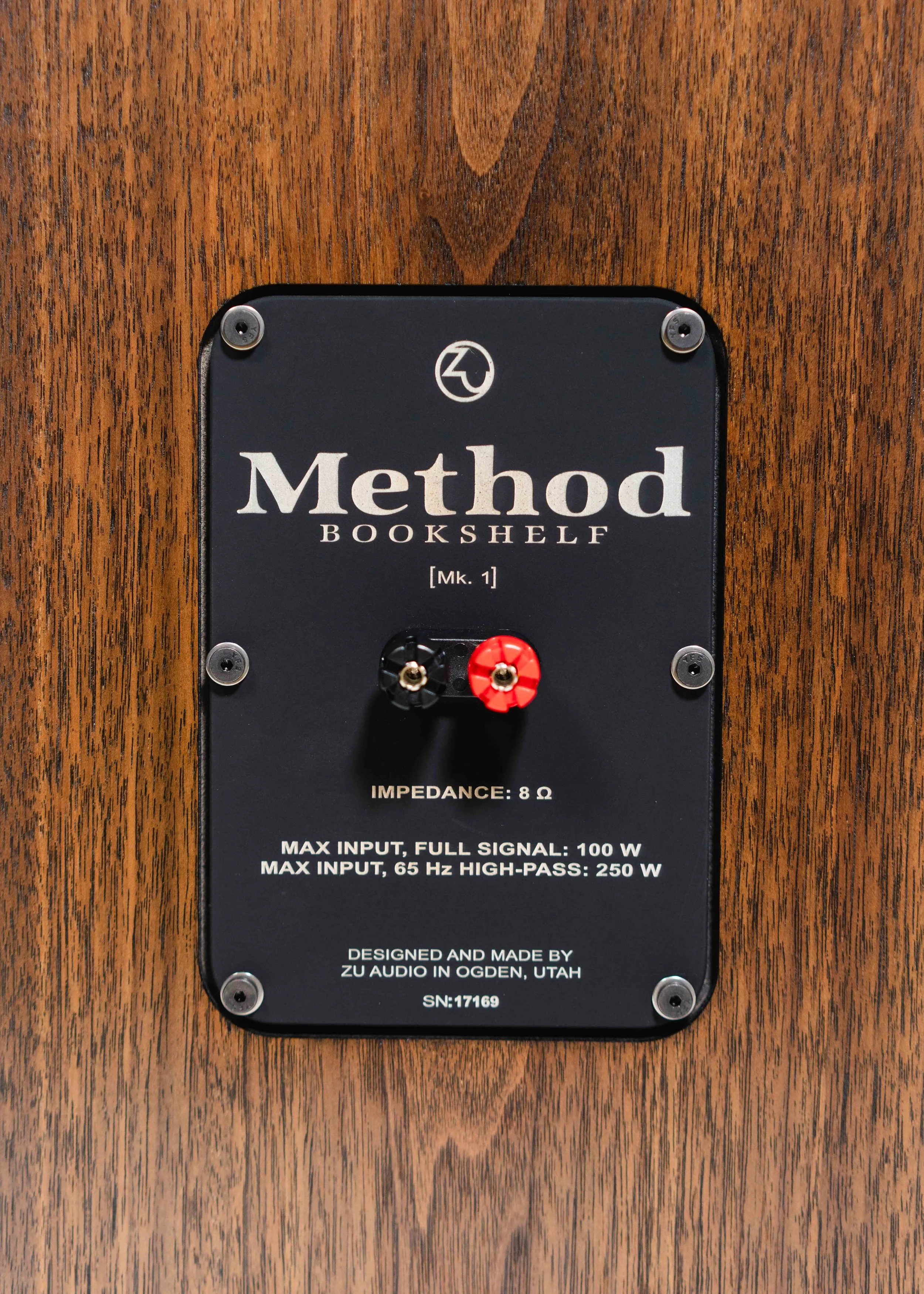 Nameplate photo of Zu Method Bookshelf loudspeakers finished in hand rubbed dark American walnut.