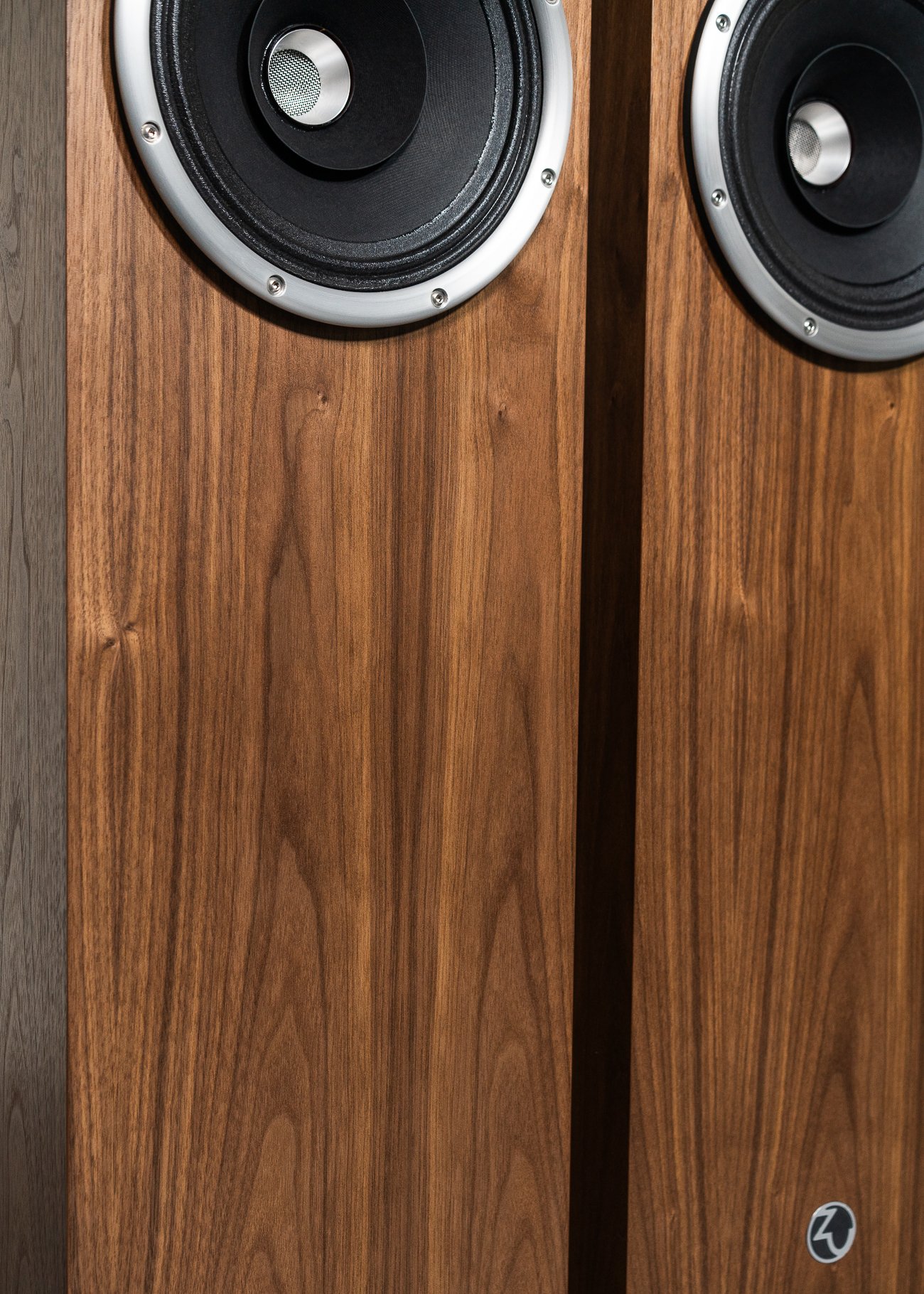 Kinda closeup, isometric view photo of Zu Union Six loudspeakers finished in American walnut and silver trim - matched pair.
