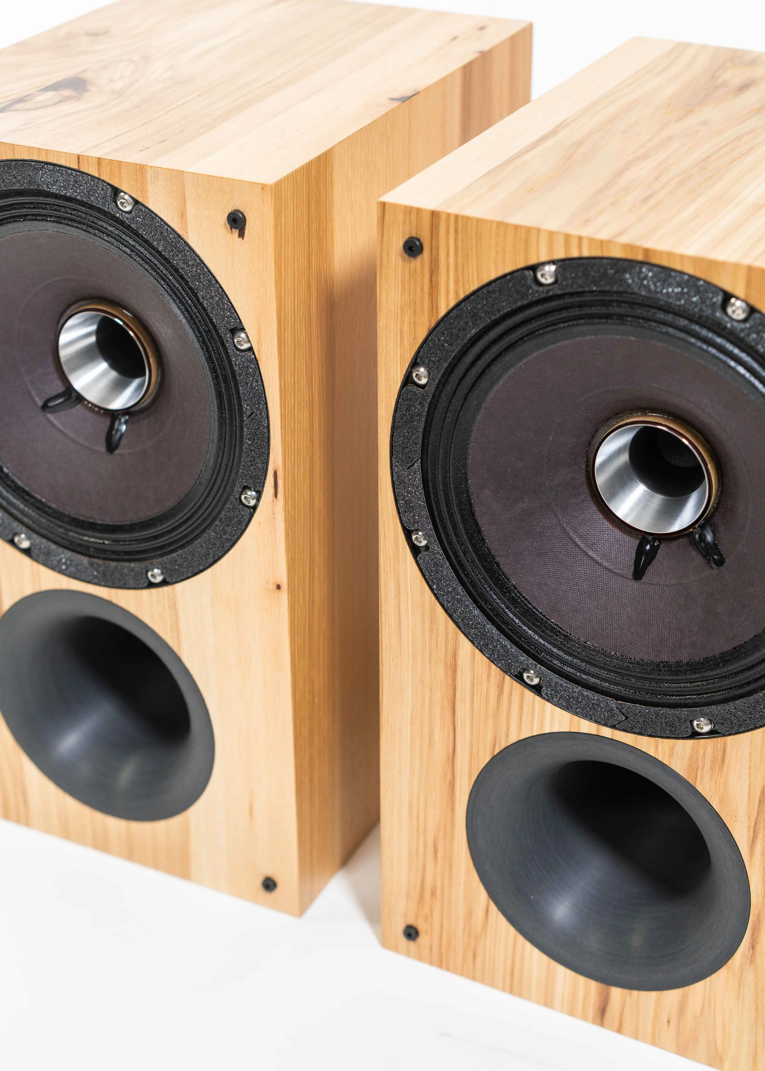 Closeup photo of Zu Method Bookshelf loudspeakers finished in rustic hickory--isometric view.