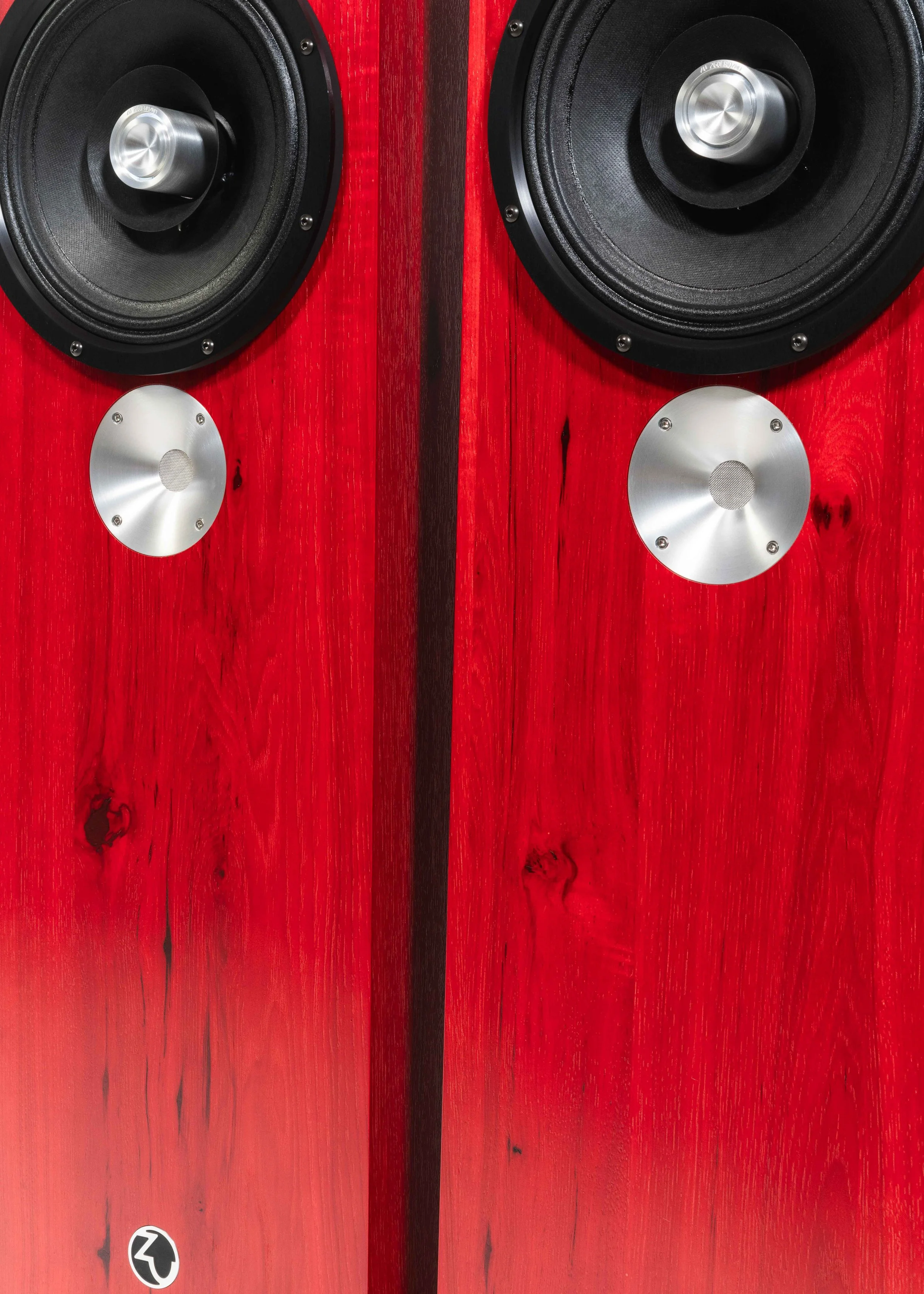 Semi-closeup photo of Zu DW-6 loudspeakers finished in ruby red hickory and feature black anodized trim-ring