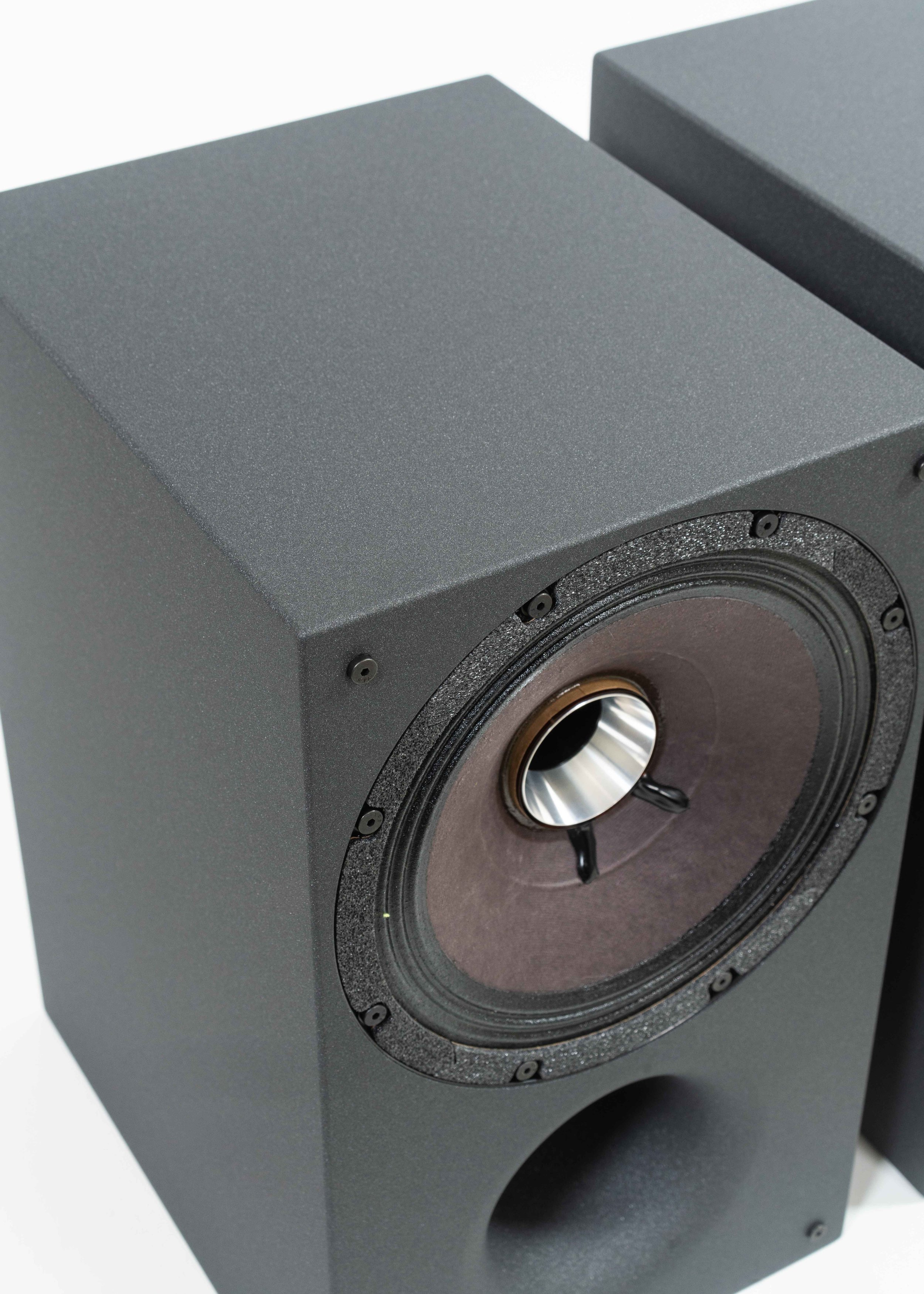 Closeup photo of Zu Method Bookshelf pair finished in cosmic carbon including port tube.