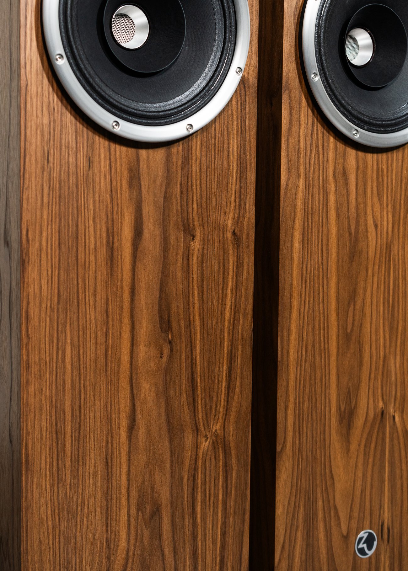 Kinda closeup photo of Zu Union Six loudspeakers finished in American walnut and silver trim.