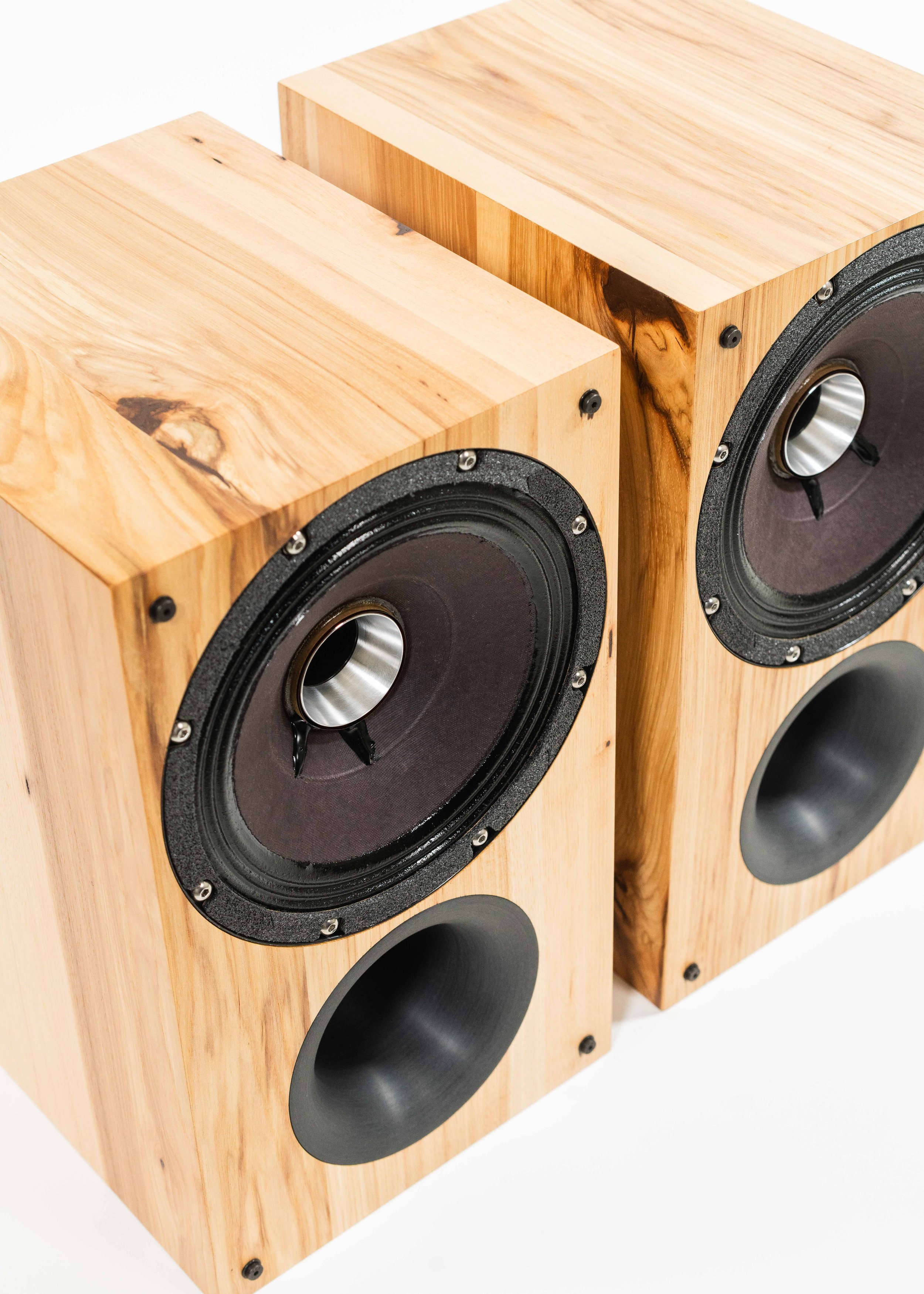 Closeup photo of Zu Method Bookshelf speakers finished in rustic hickory.