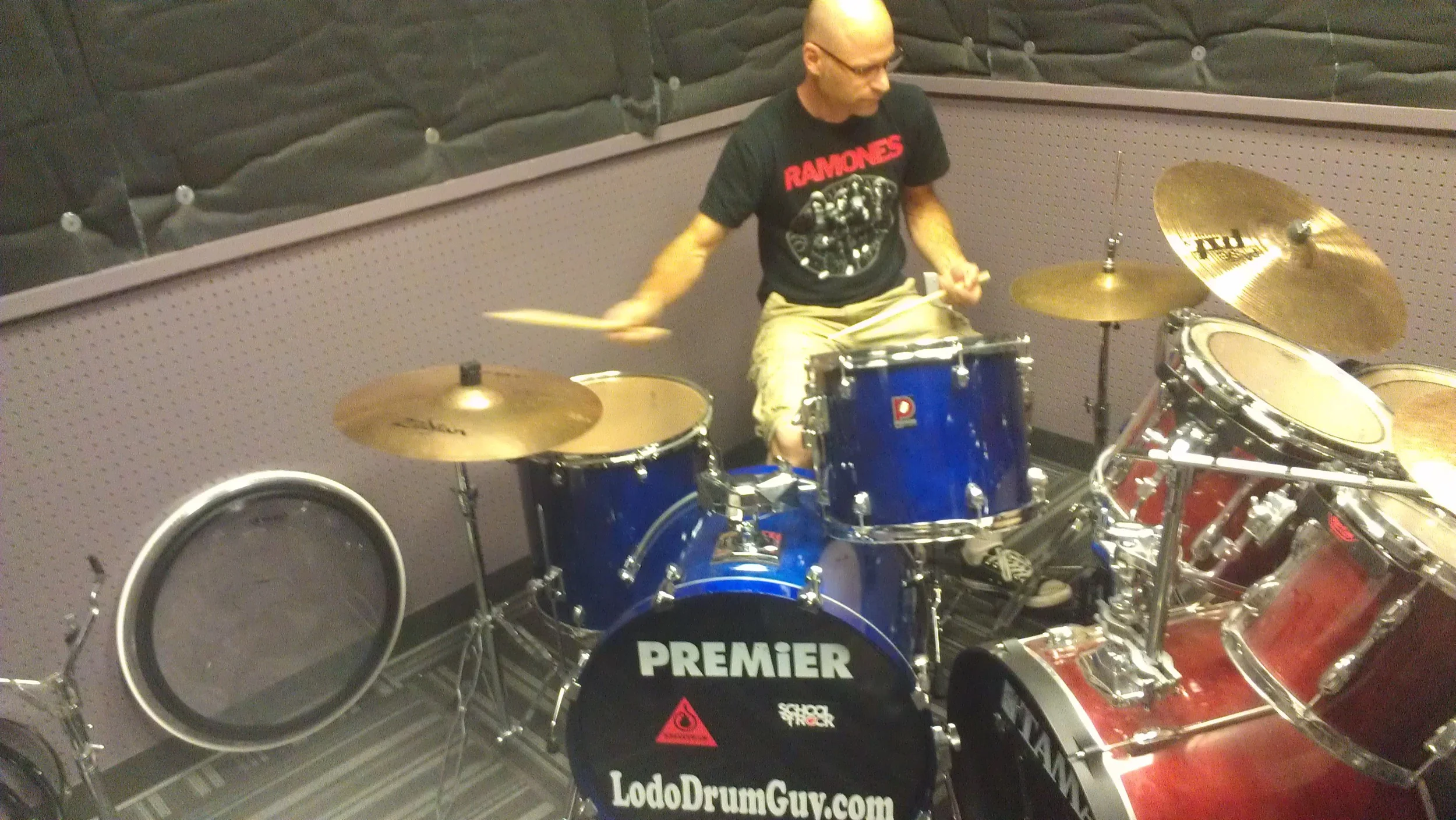 Chris Soucy, Mountain Regional Manager, test driving School of Rock's new house drum kit.