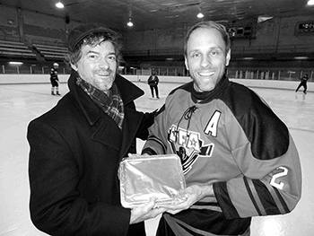 MARTY DESJARDINS THE 1ST EVER WINNER OF THE PLAYER OF THE MONTH AWARD, RECEIVING A HOME MADE SHEPARD PIE FROM THE PRESIDENT OF THE LFA LAST FALL