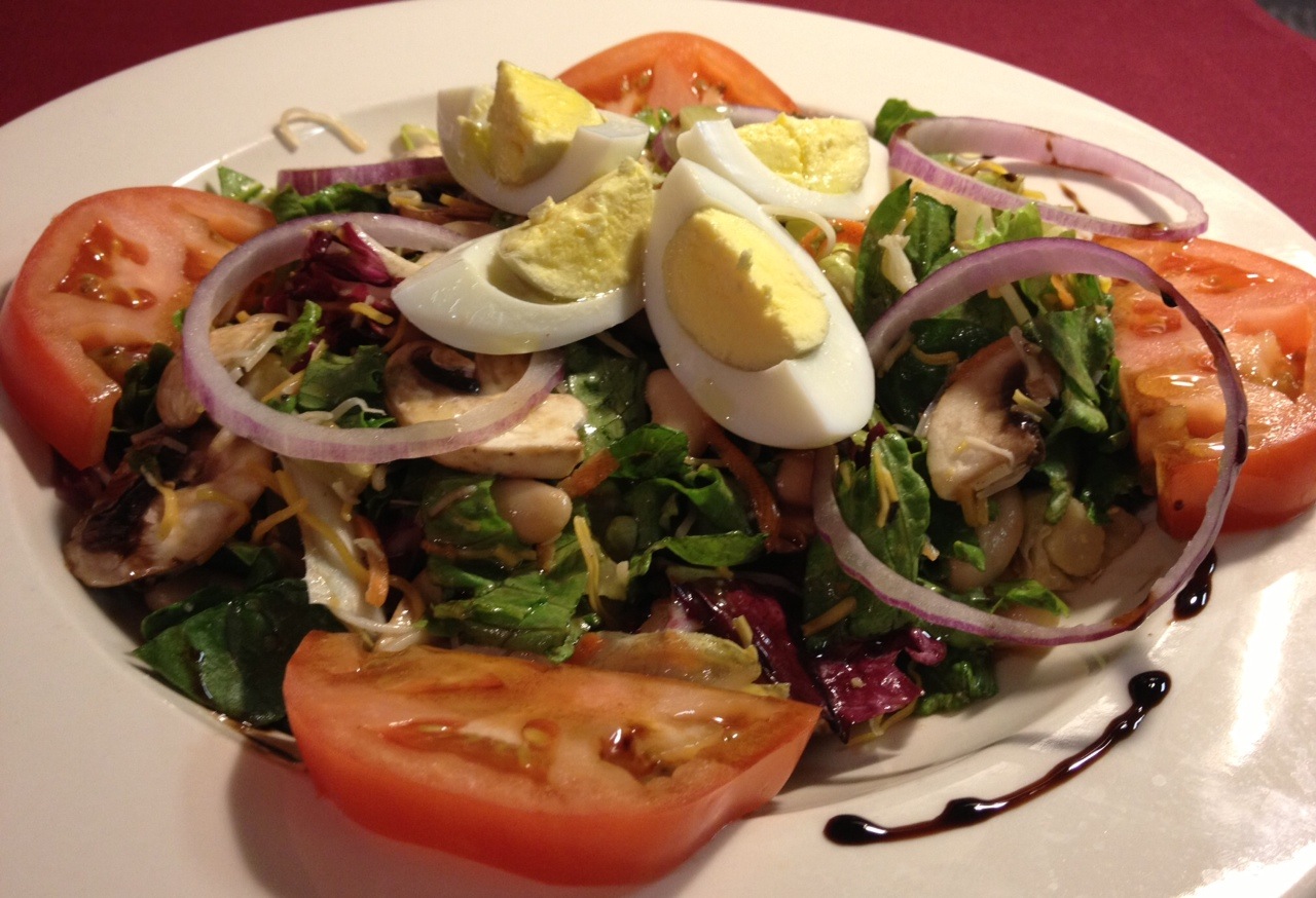 Quiet Man Tossed Salad...Mixed Greens, Hard-Cooked Egg,  Pickled Beets, Tomatoes, Mushrooms, Thin Red Onions, Raw Carrots served with Vinaigrette Dressing