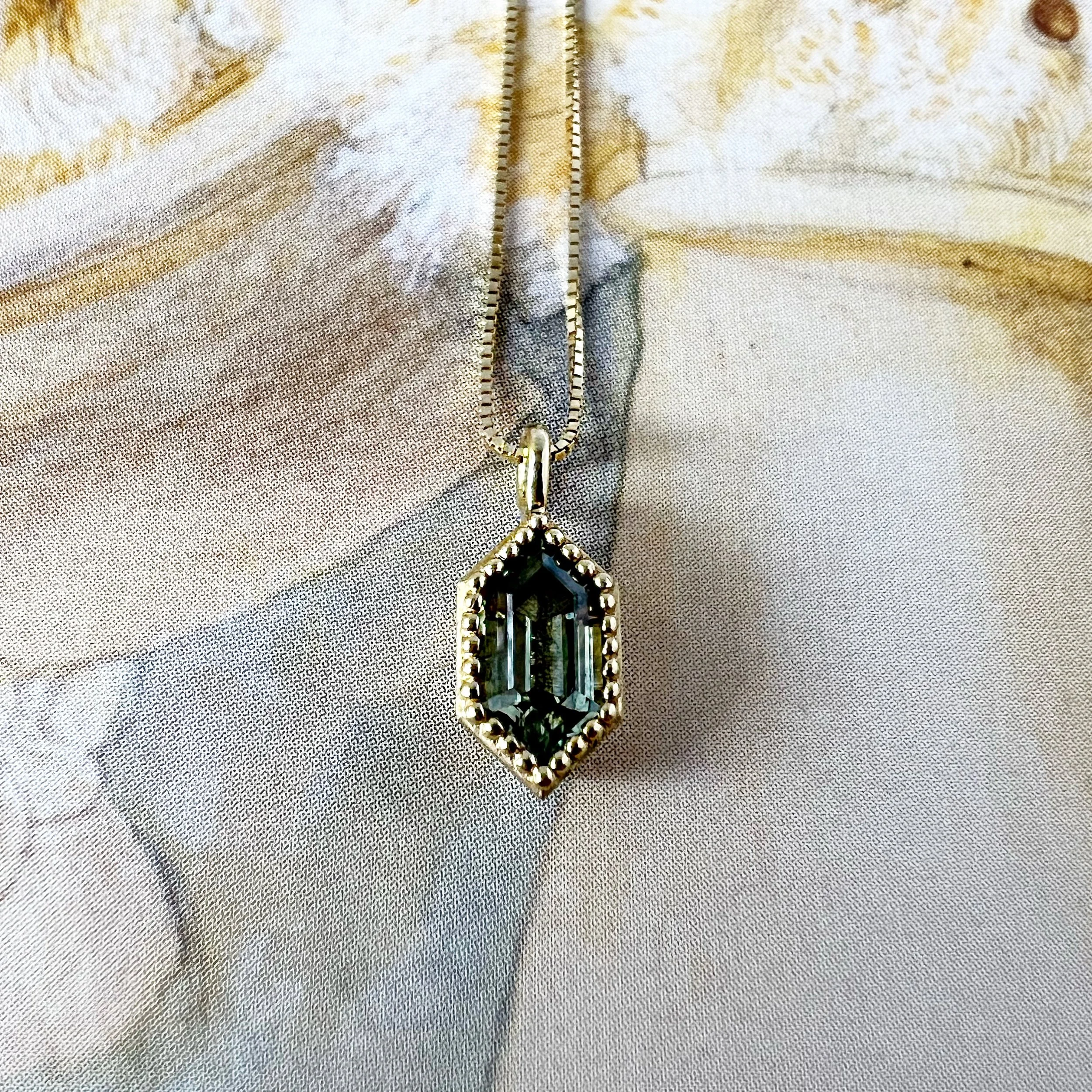 Geometric-sapphire-necklace-in- beasded-bezel.JPG