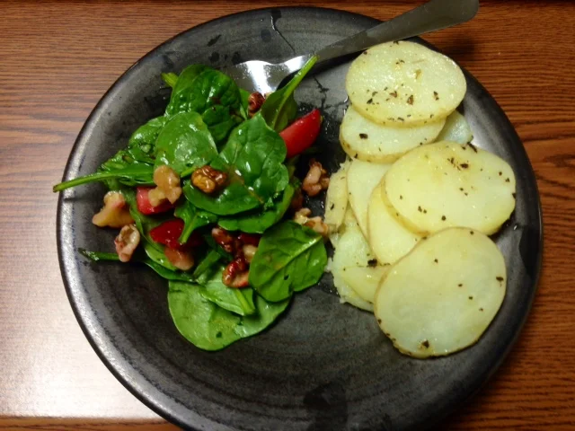 Spinach-strawberry-walnut salad with baked russet potatoes, tossed in olive oil, seat salt and pepper