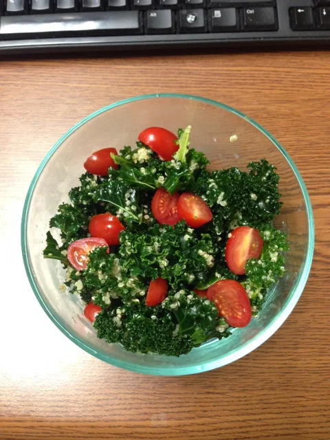 Kale-quinoa salad with cherry tomatoes, tossed in homemade olive oil-garlic-lemon dressing