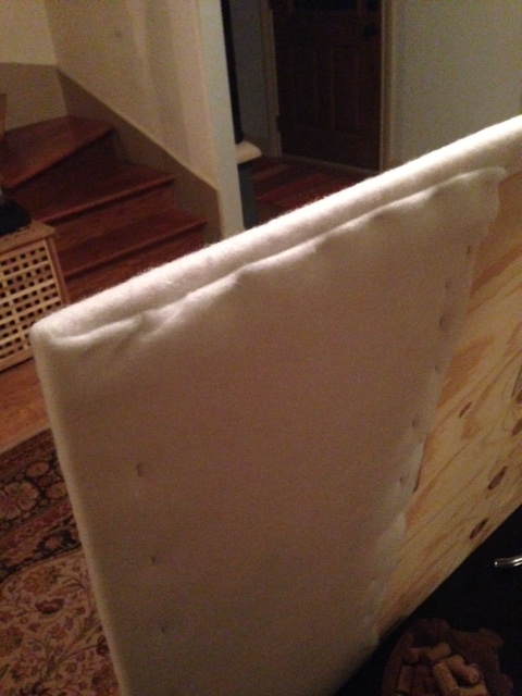 Step Three: Staple batting to plywood with staple gun. Fold and staple corners as if you're wrapping a giant gift.