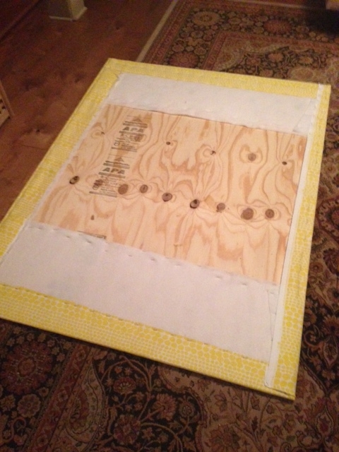 Step Four: Repeat batting steps with fabric of choice over stapled batting. The back will be against the wall so no need to be a perfectionist on this. Just insure all corners are tight so there's no wrinkles in the front.