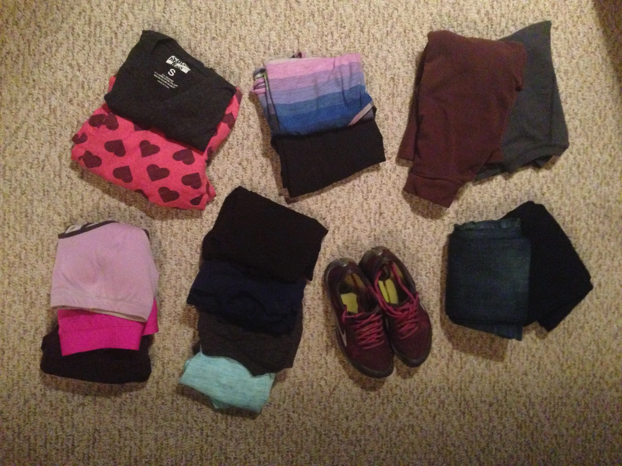 Left to right, top to bottom: PJ pants and two pairs of tee shirts, workout outfit, two sweaters (wound up only packing one and a not-pictured jacket), sports bras, five shirts (one long-sleeve, one 3/4 sleeve, three short-sleeved), walking shoes, two pairs of jeans (one medium-wash, one dark wash).