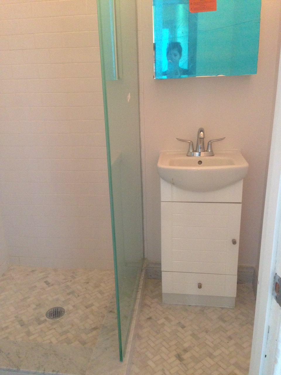Shot of the tiny bathroom - first door you see when you walk into apartment from front door. 