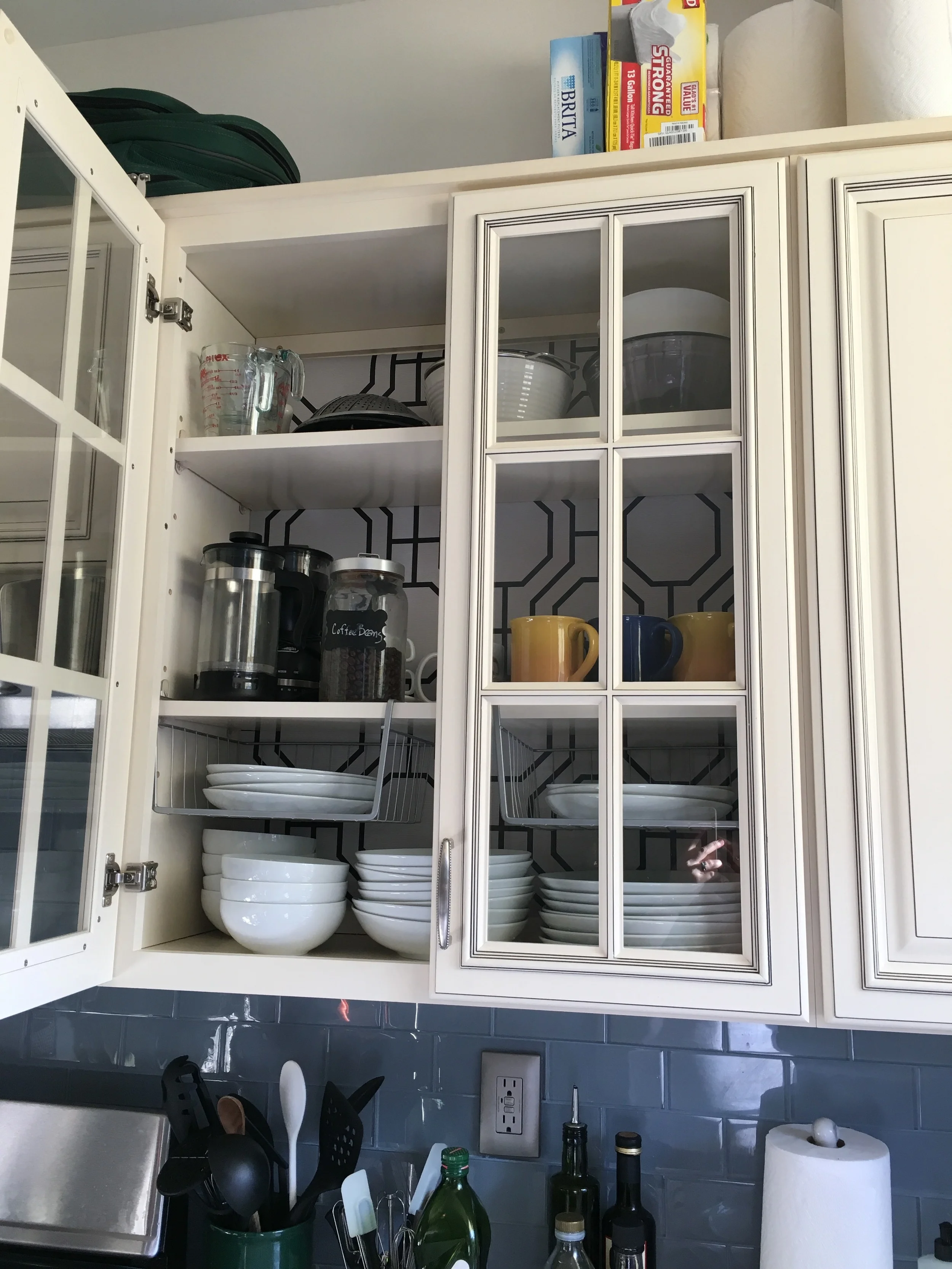 Wallpaper-backed kitchen cabinets