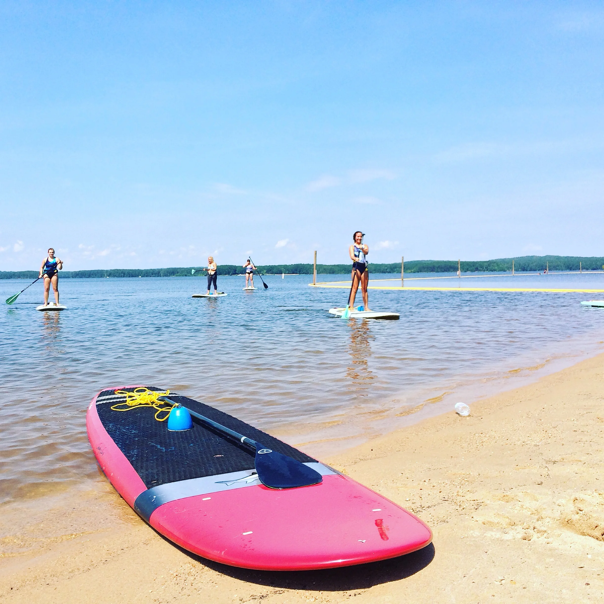 Students blissfully paddle in post SUP Yoga practice
