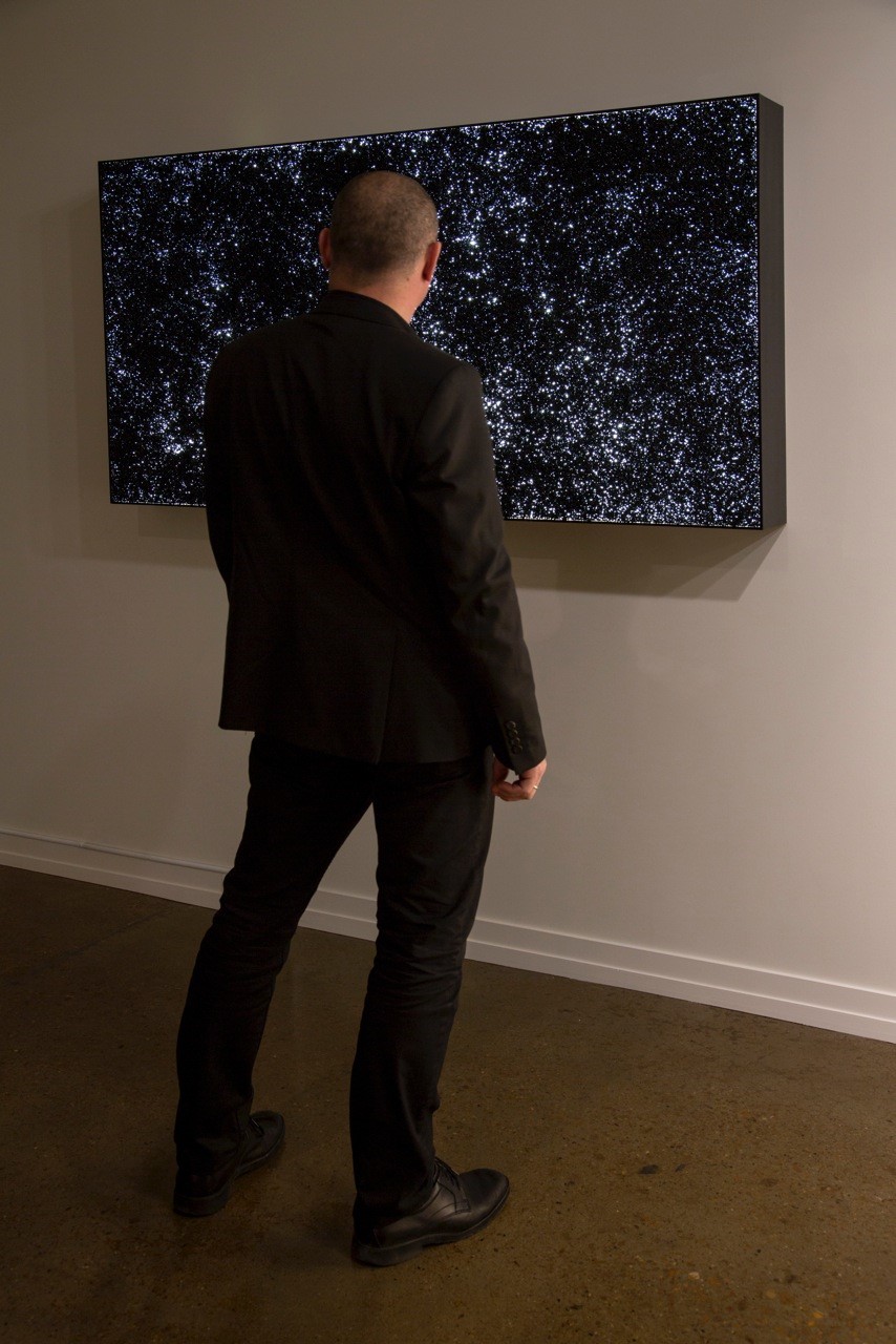 Installation of My God, It's Full of Stars, vinyl pellets on lightbox, 36"x66", 2014