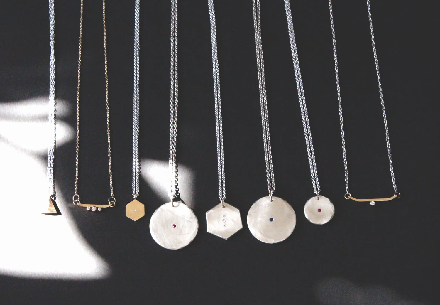 Ida , Alpine Trio , Ruby Odessa , Diamond Hexagon, Sapphire Odessa , Small Ruby Odessa , and Alpine Diamond necklaces