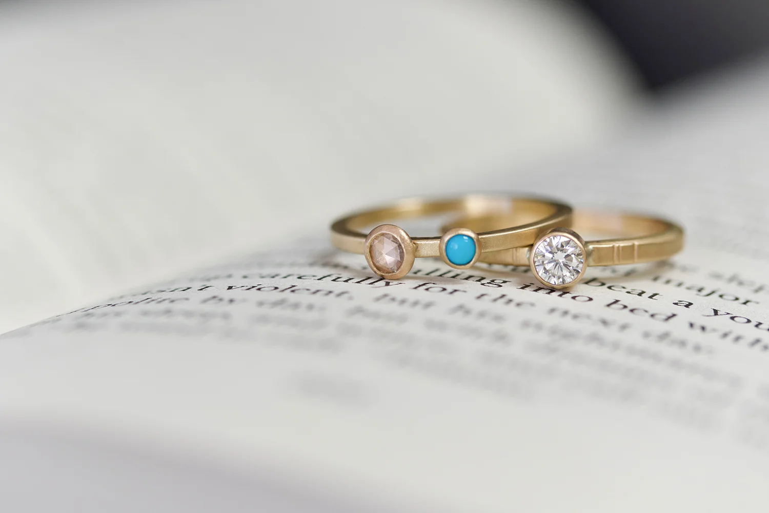 georgia and diamond granite rings on book small.jpg