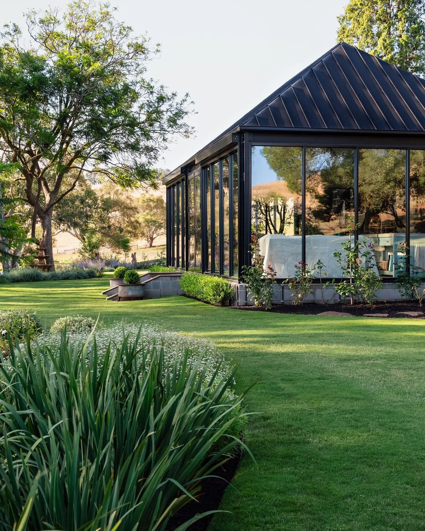 .
SUTHERLANDS RESIDENCE
Nestled within a stunning landscape, a sleek contemporary extension seamlessly integrates with the historical charm of the bluestone cottage 
Builder: @tvdgroupbuilders 
Photography: @erikholtphotography 
Landscaping: @lath