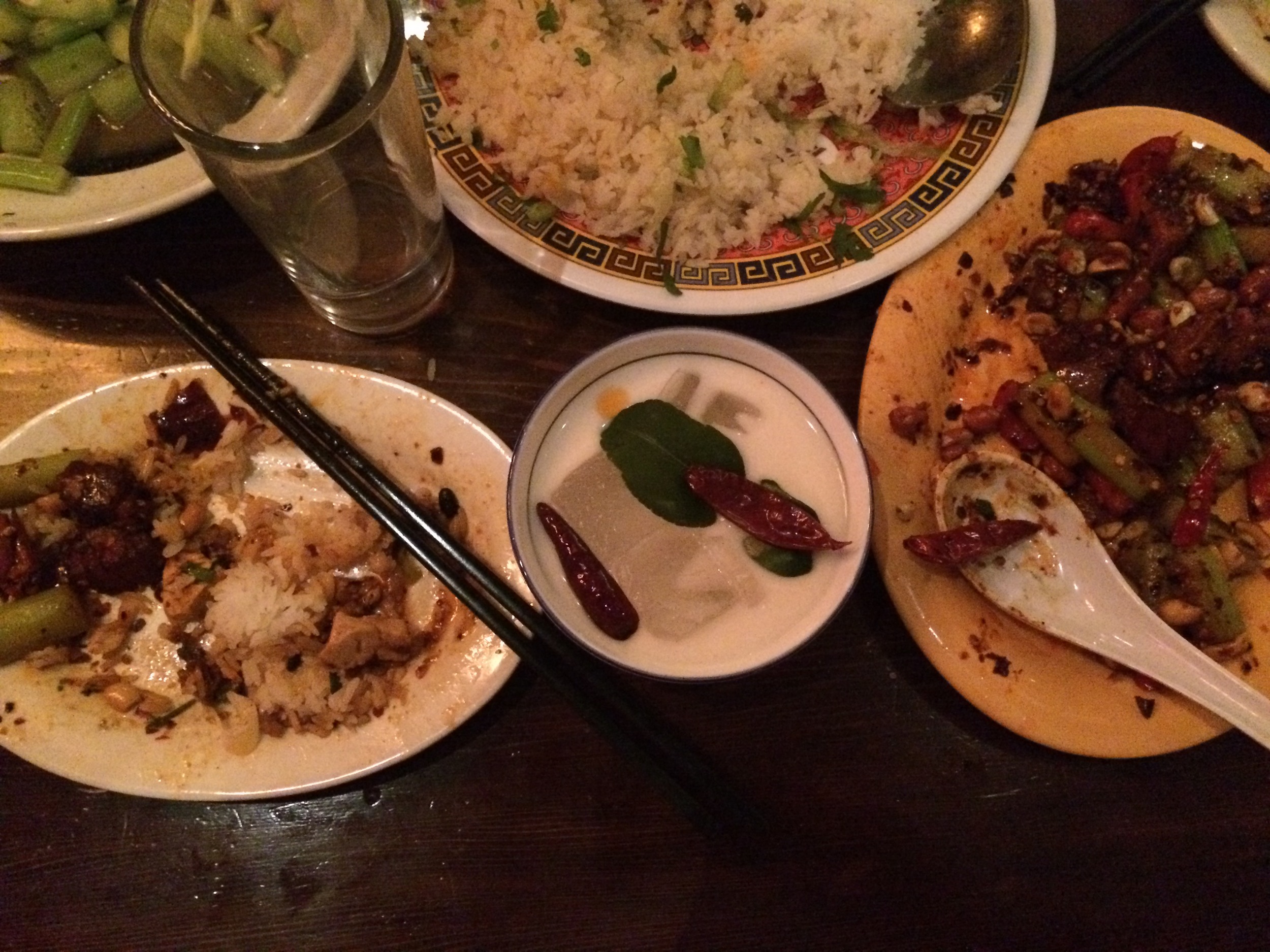 A Phil Khallins, one of Mission Chinese's unique and delicious cocktails, sits amongst a bounty of Bowien's offerings.