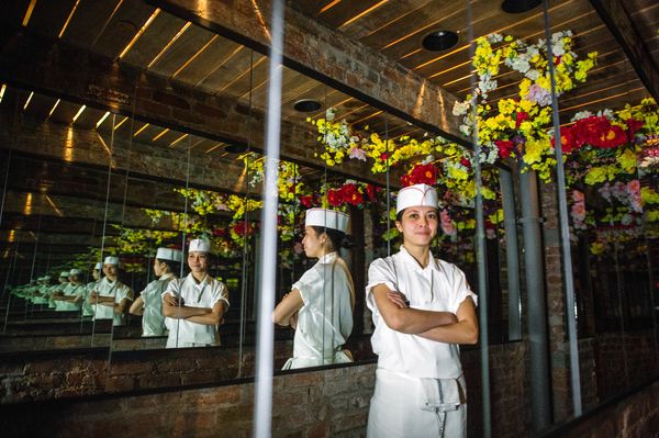Executive Chef Angela Dimayuga stands in the downstairs hallway that also leads to the restrooms. Another hidden treasure to the restaurant, everyone should make an excuse to visit the bathroom while dining. (Photo Credit:Eater)